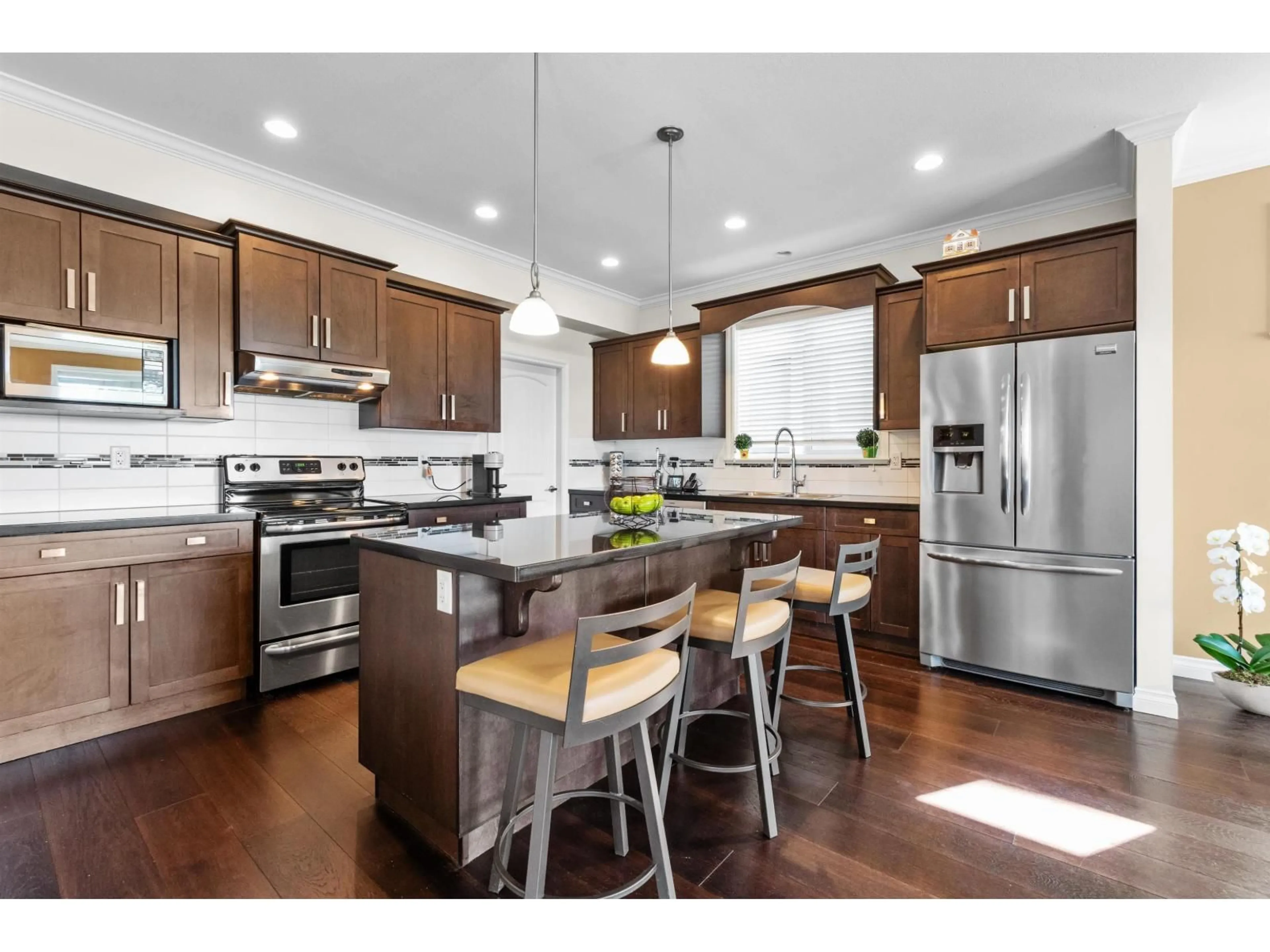 Open concept kitchen, wood/laminate floor for 6898 177 STREET, Surrey British Columbia V3S2K1