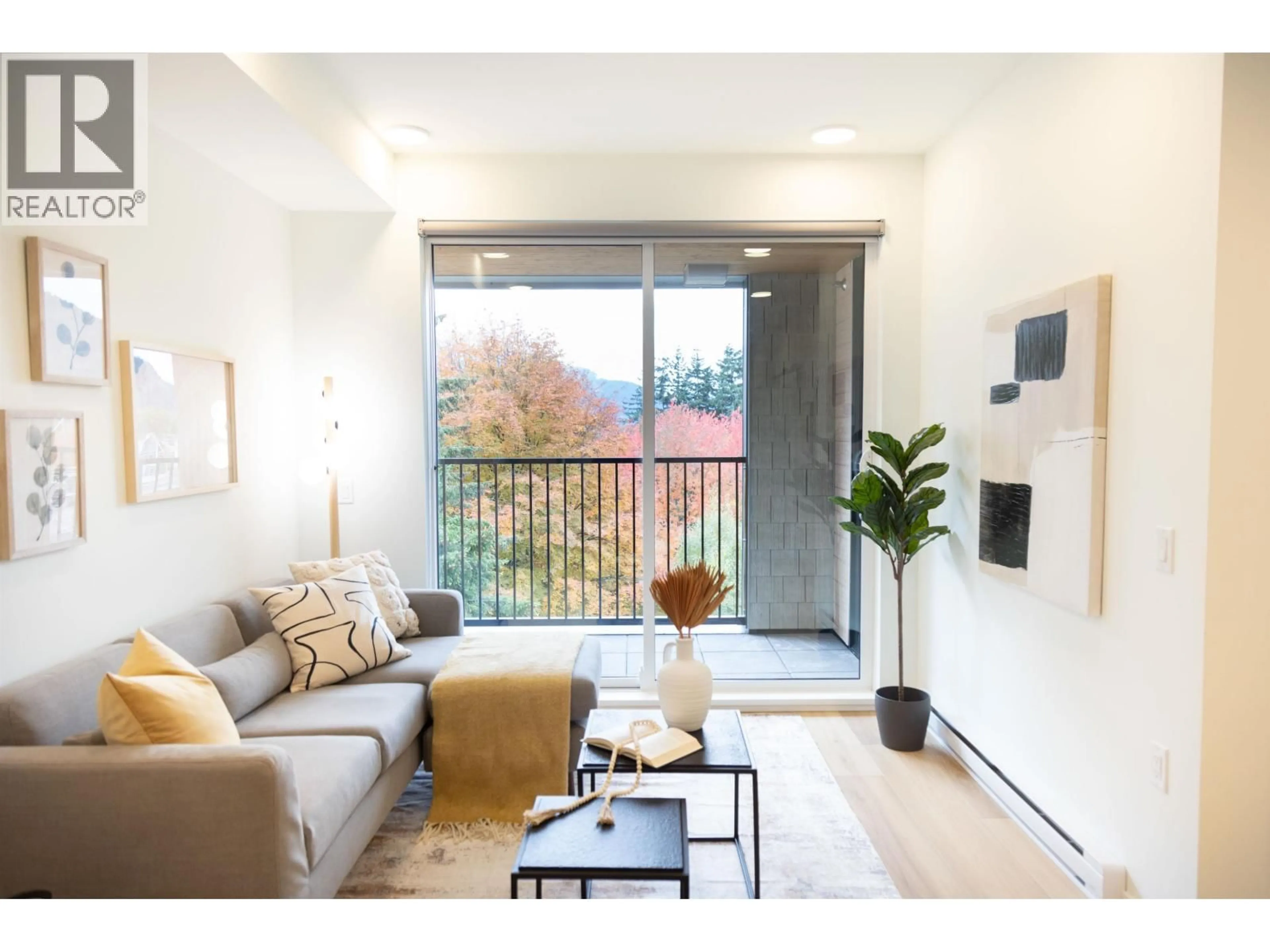 Living room with furniture, wood/laminate floor for 406 - 37994 SECOND AVENUE, Squamish British Columbia V8B0C3