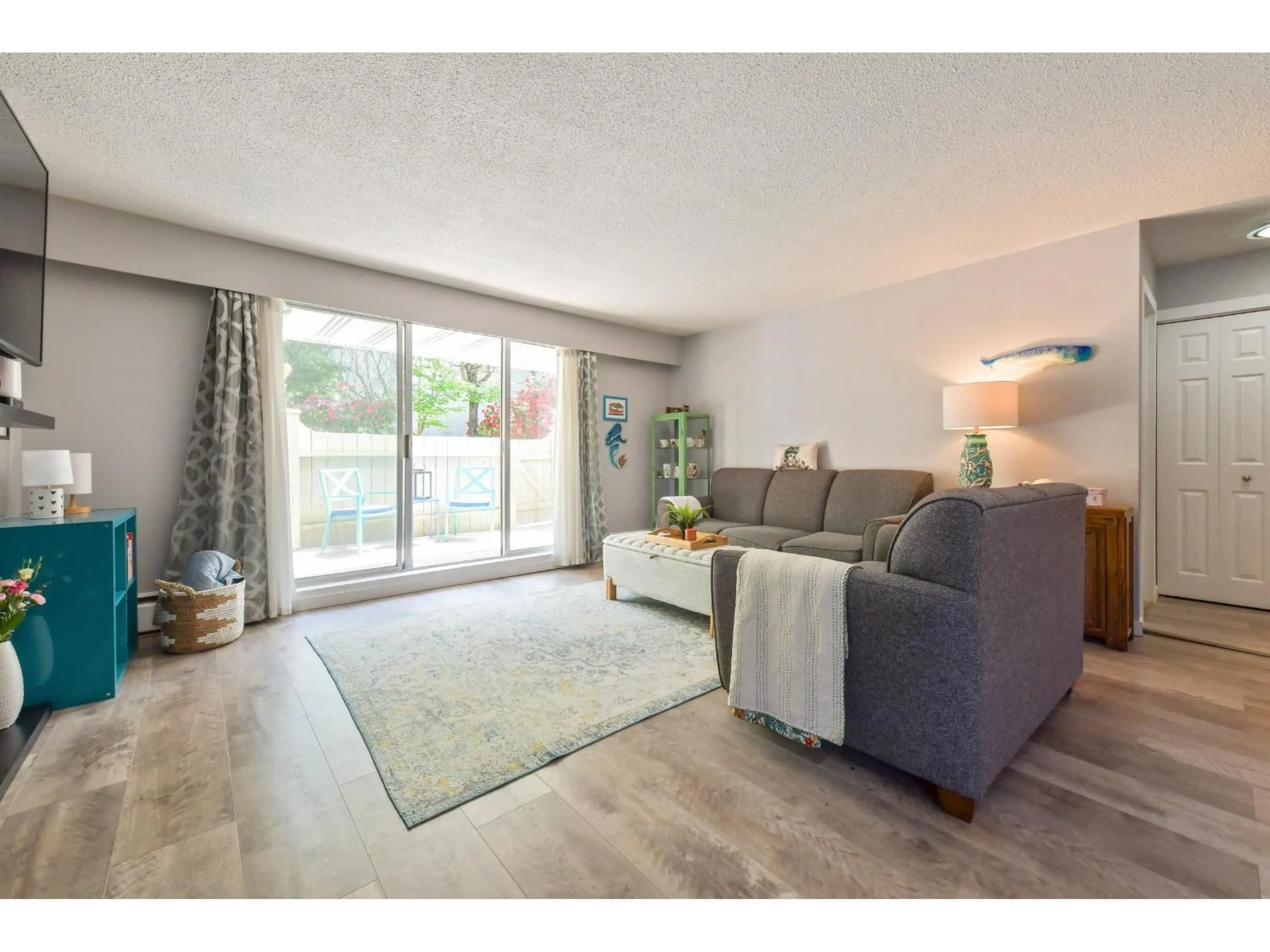 Living room with furniture, wood/laminate floor for 206 - 15010 ROPER AVENUE, White Rock British Columbia V4B5A9