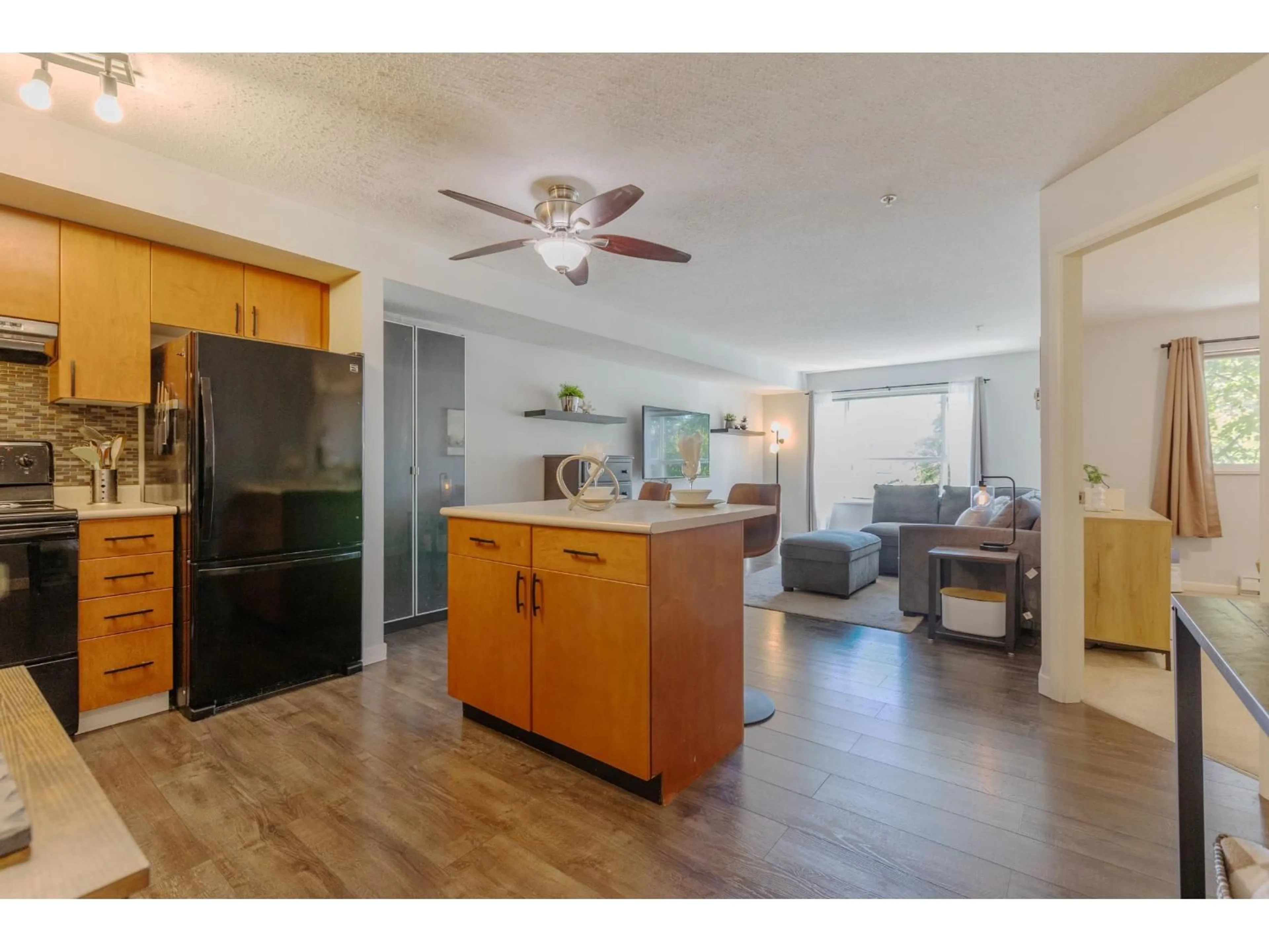 Open concept kitchen, wood/laminate floor for 306 - 5465 203 STREET, Langley British Columbia V3A9L8