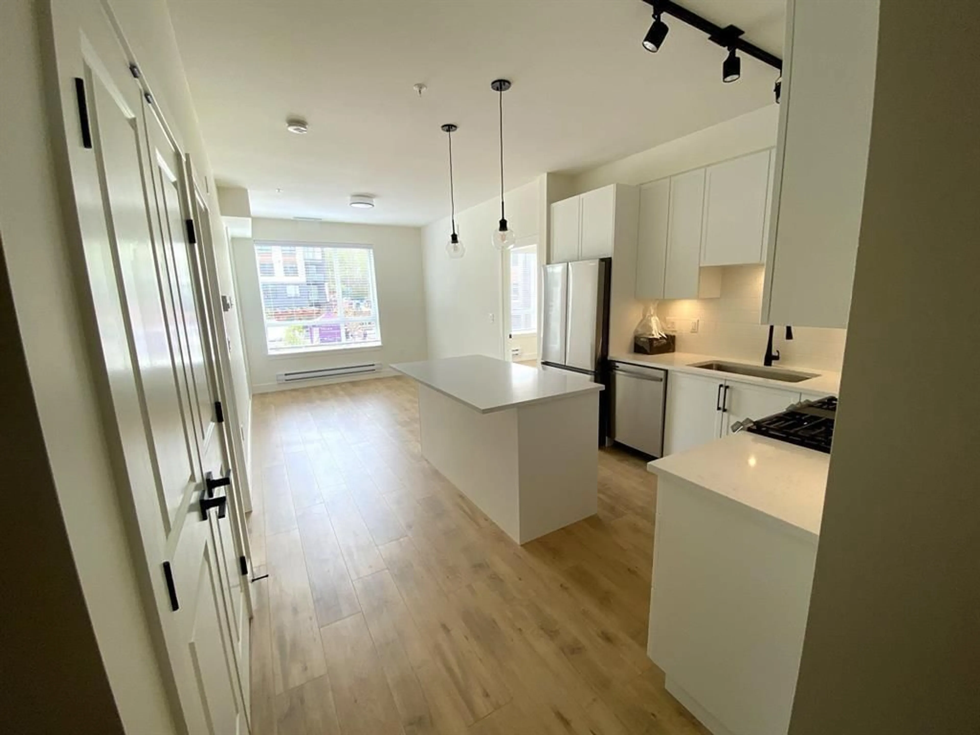 Open concept kitchen, wood/laminate floor for 206 - 19935 75A AVENUE, Langley British Columbia V2Y4L6
