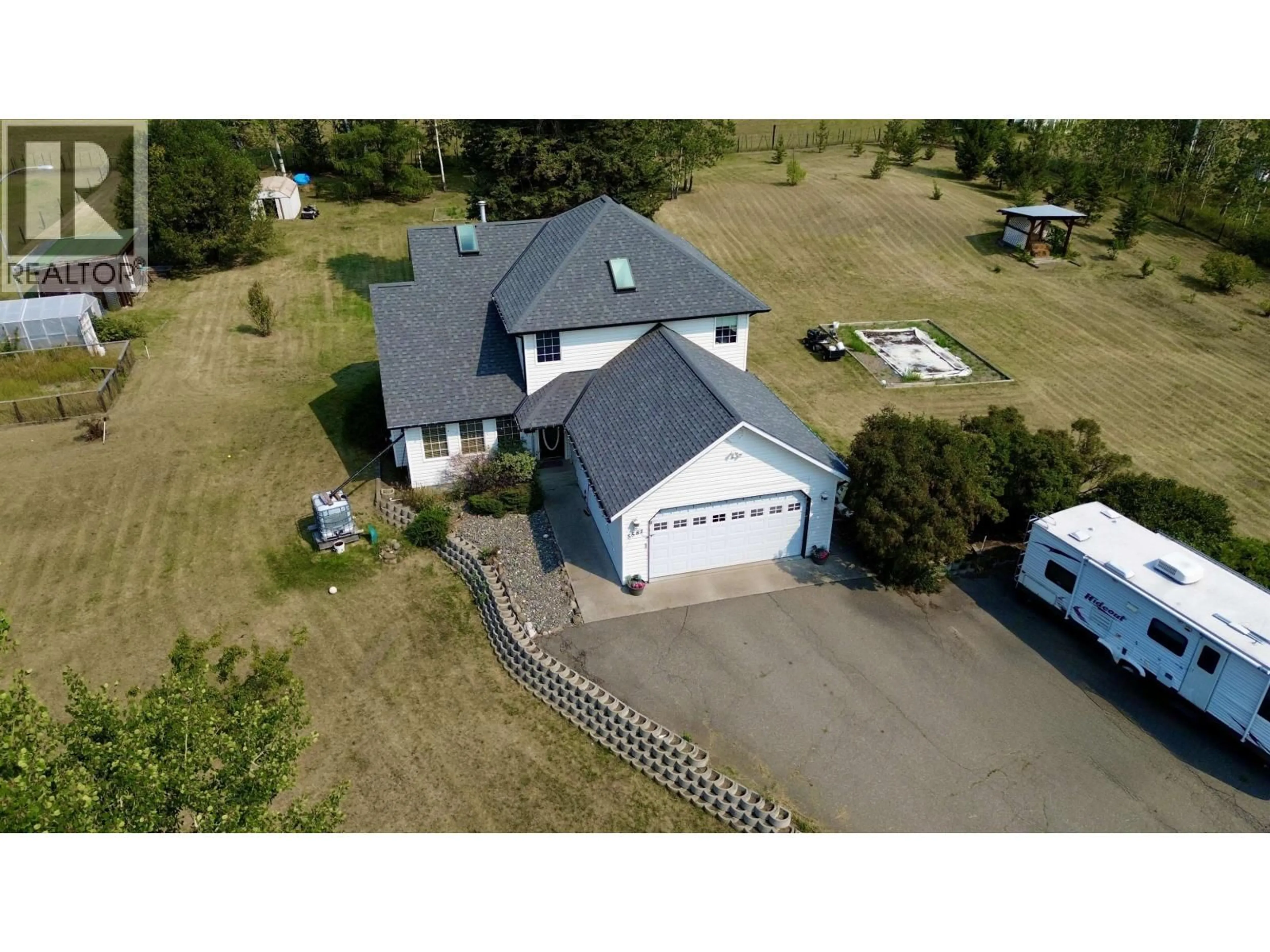 A pic from outside/outdoor area/front of a property/back of a property/a pic from drone, building for 5581 LAKESIDE COURT, 103 Mile House British Columbia V0K2E1