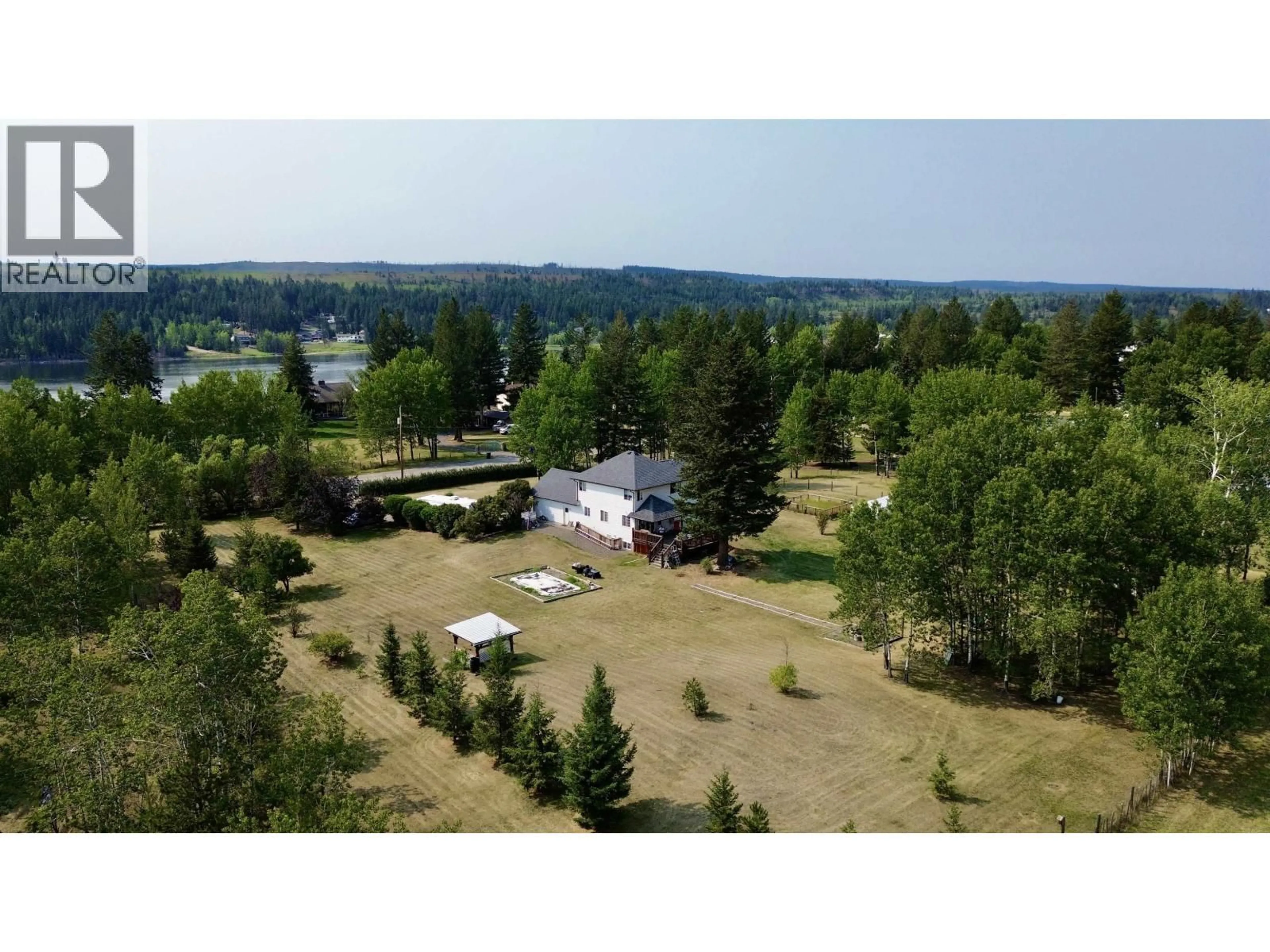 A pic from outside/outdoor area/front of a property/back of a property/a pic from drone, water/lake/river/ocean view for 5581 LAKESIDE COURT, 103 Mile House British Columbia V0K2E1