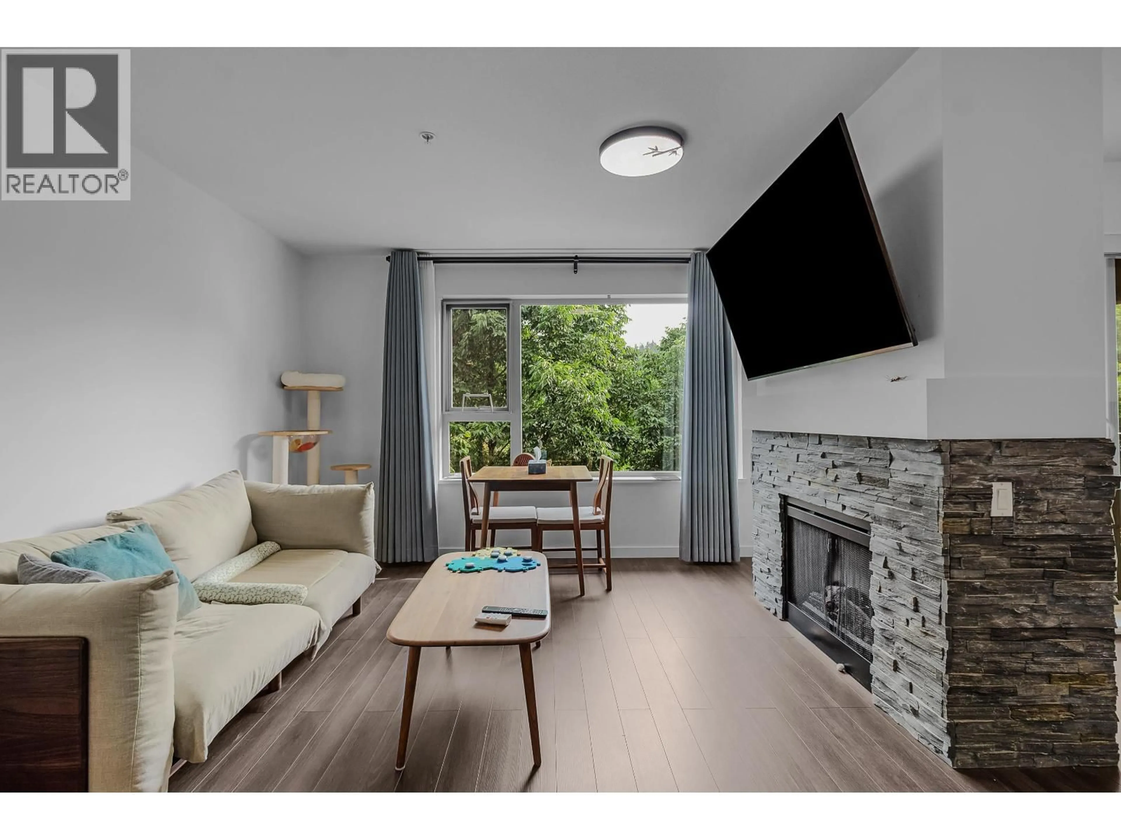 Living room with furniture, wood/laminate floor for 309 - 200 KLAHANIE DRIVE, Port Moody British Columbia V3H5K7