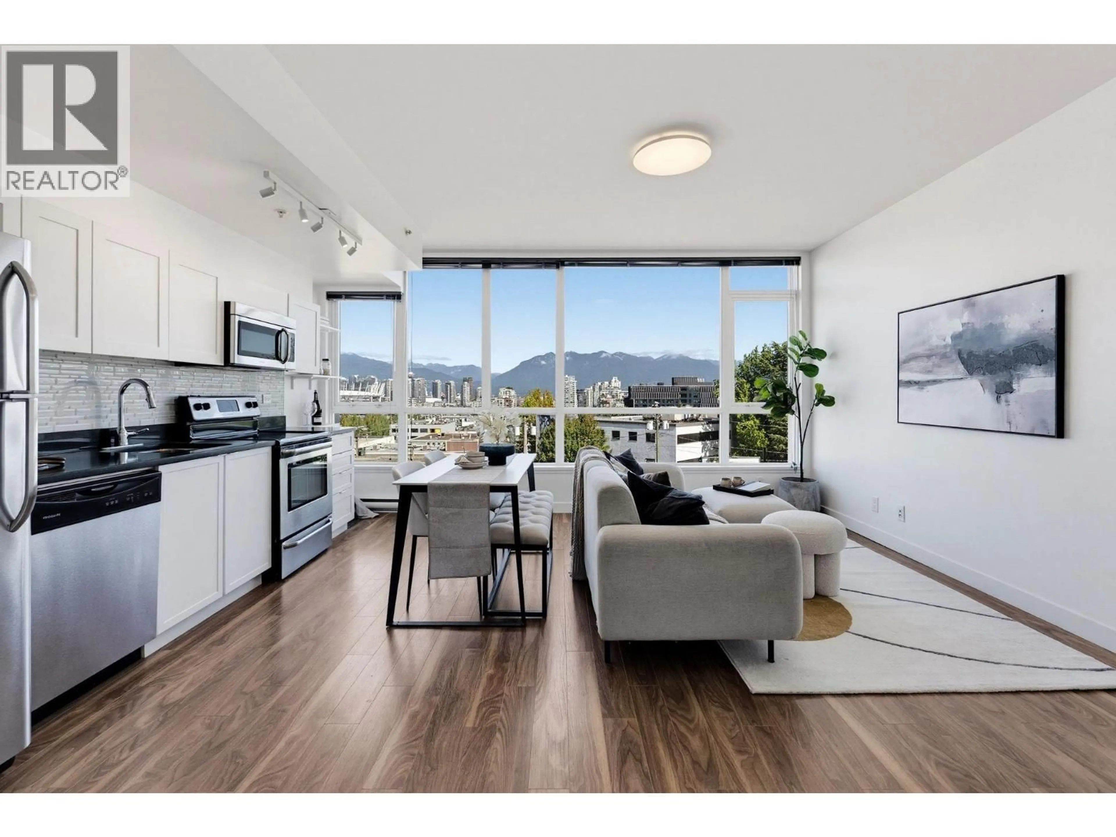 Living room with furniture, wood/laminate floor for 409 - 2511 QUEBEC STREET, Vancouver British Columbia V5T0B6
