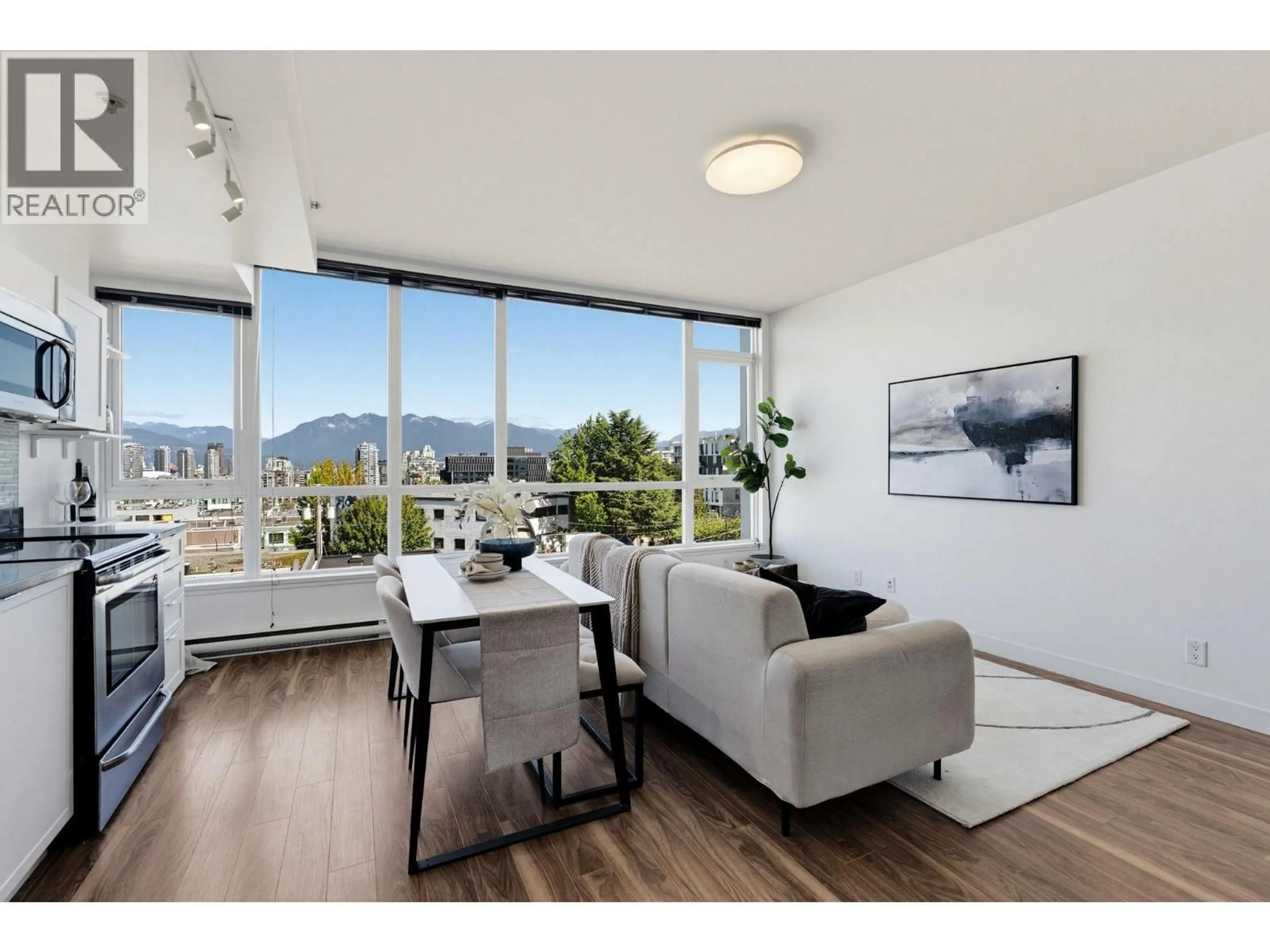 Living room with furniture, wood/laminate floor for 409 - 2511 QUEBEC STREET, Vancouver British Columbia V5T0B6
