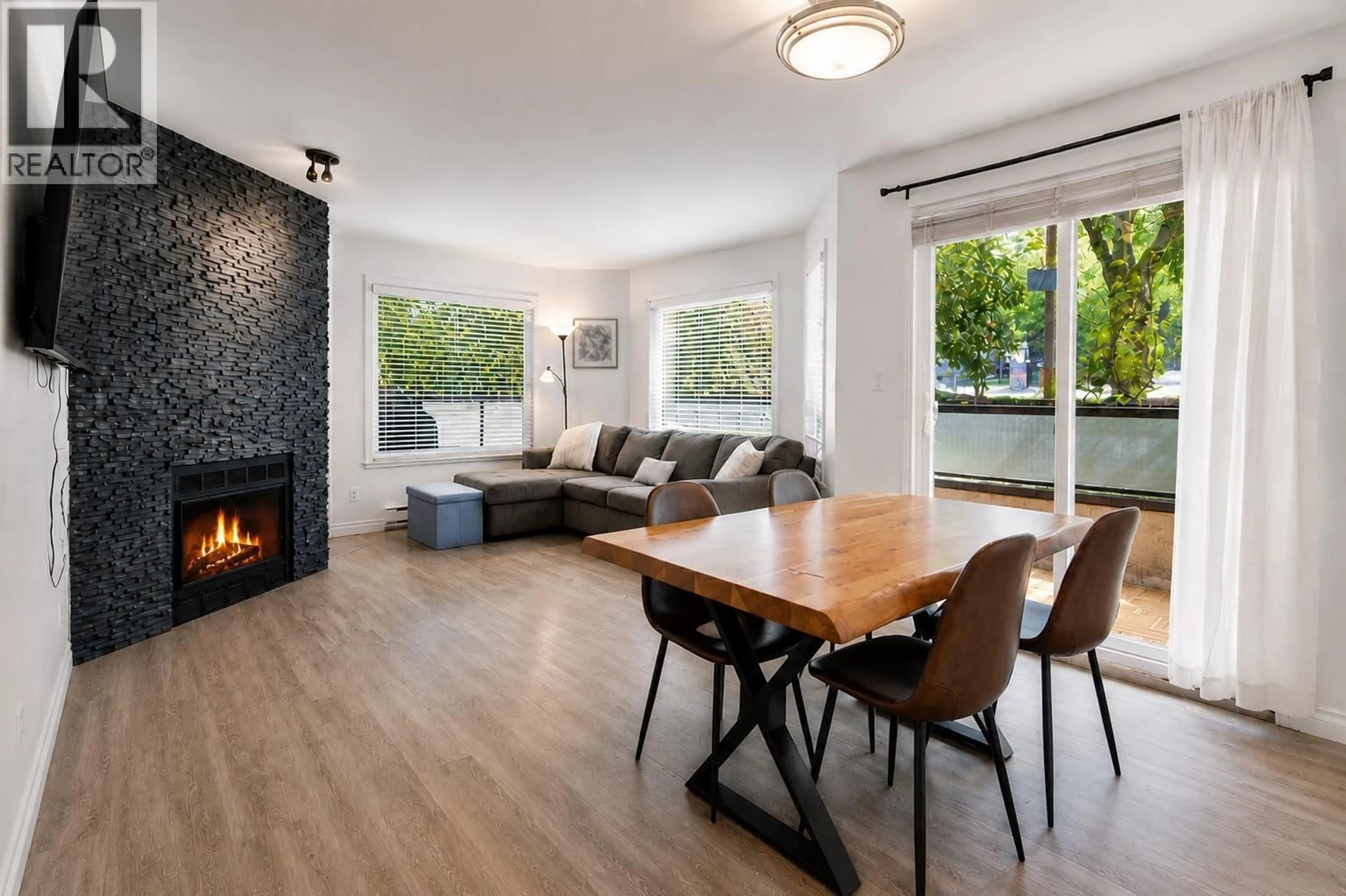 Living room with furniture, wood/laminate floor for 101 - 175 4TH STREET, North Vancouver British Columbia V7M1H6