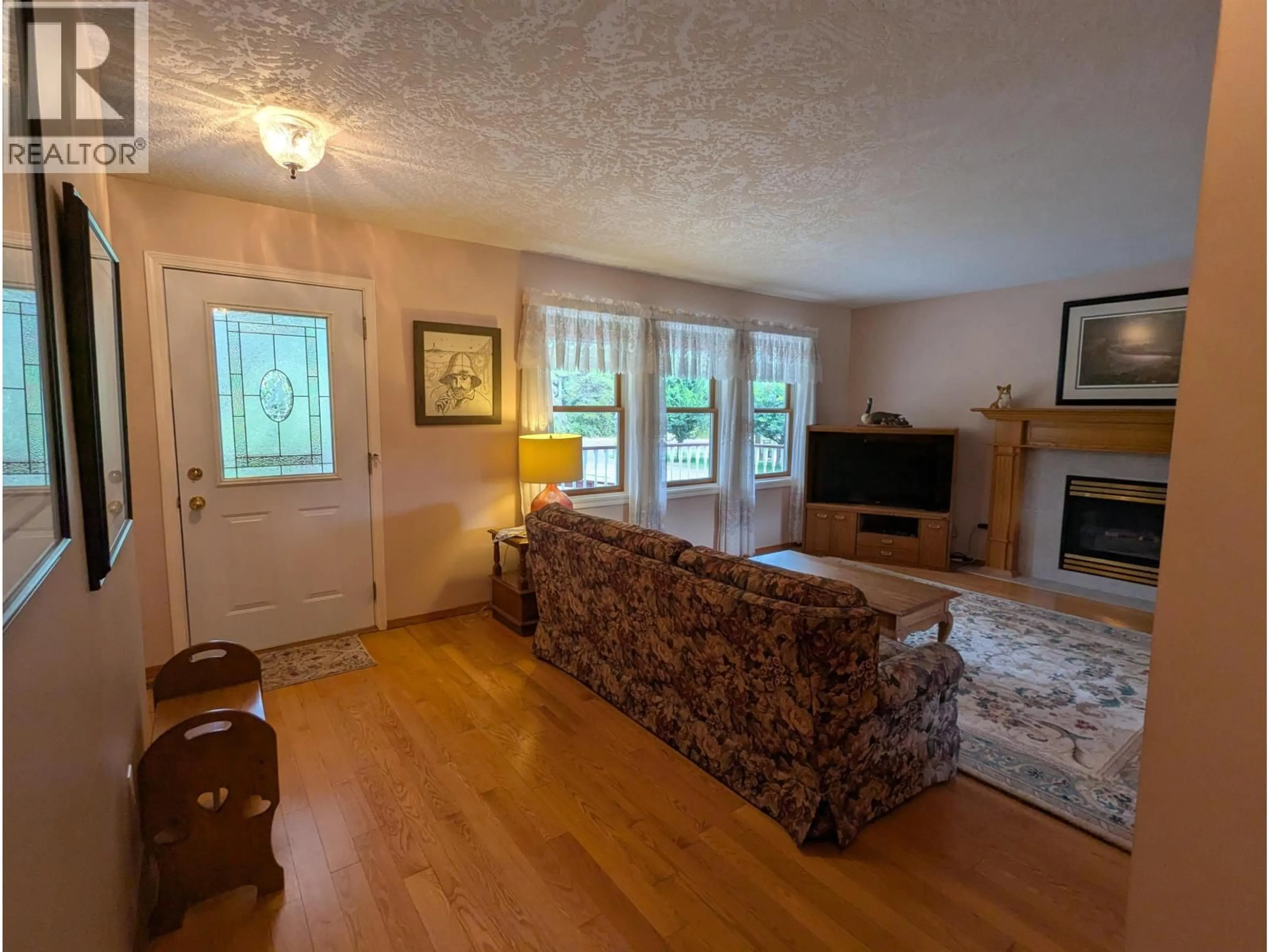 Living room with furniture, wood/laminate floor for 1289 COTTONWOOD STREET, Telkwa British Columbia V0J2X0