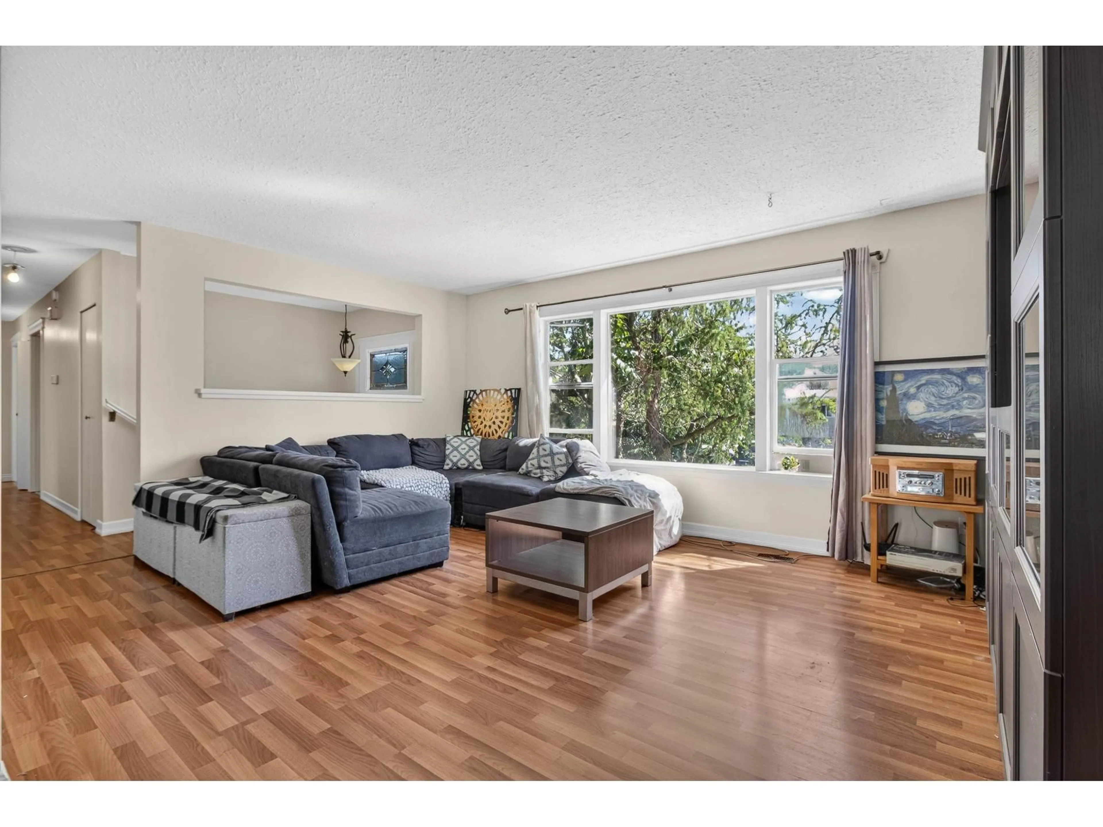 Living room with furniture, wood/laminate floor for 32539 PANDORA AVENUE, Abbotsford British Columbia V2T3S7