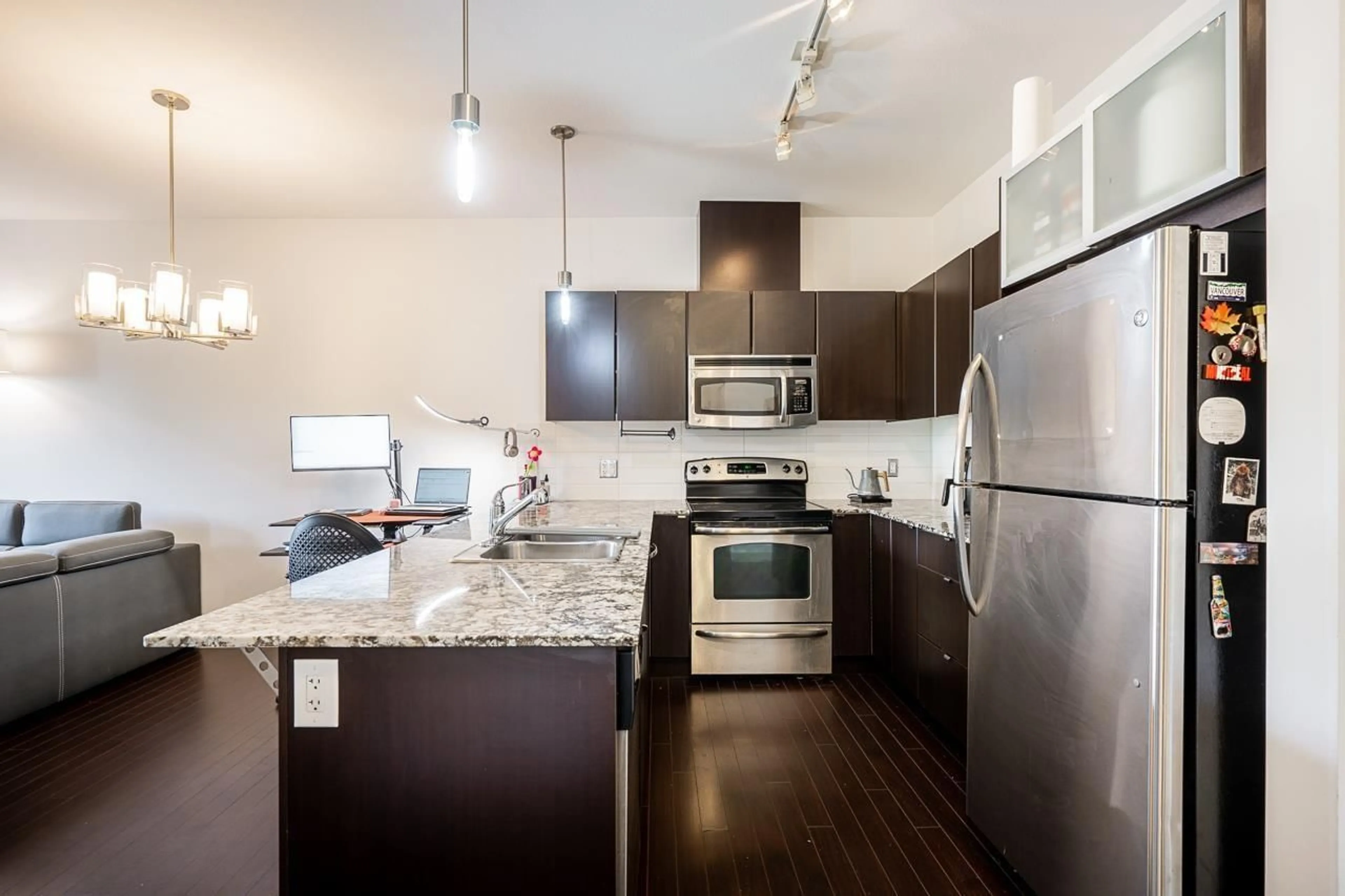 Open concept kitchen, wood/laminate floor for 410 - 9655 KING GEORGE BOULEVARD, Surrey British Columbia V3T0C7