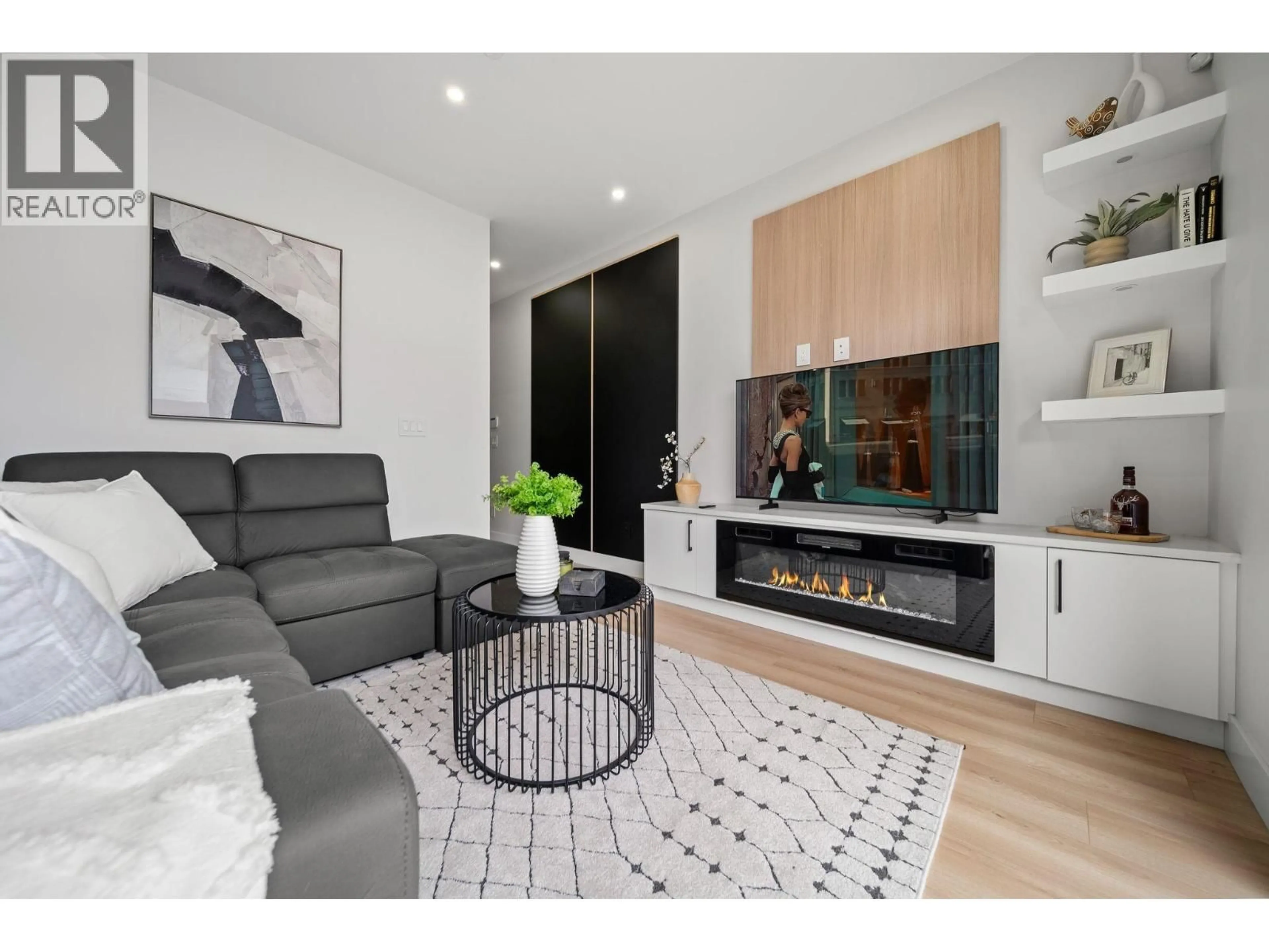 Living room with furniture, wood/laminate floor for 2369 ADANAC STREET, Vancouver British Columbia V5L2E9