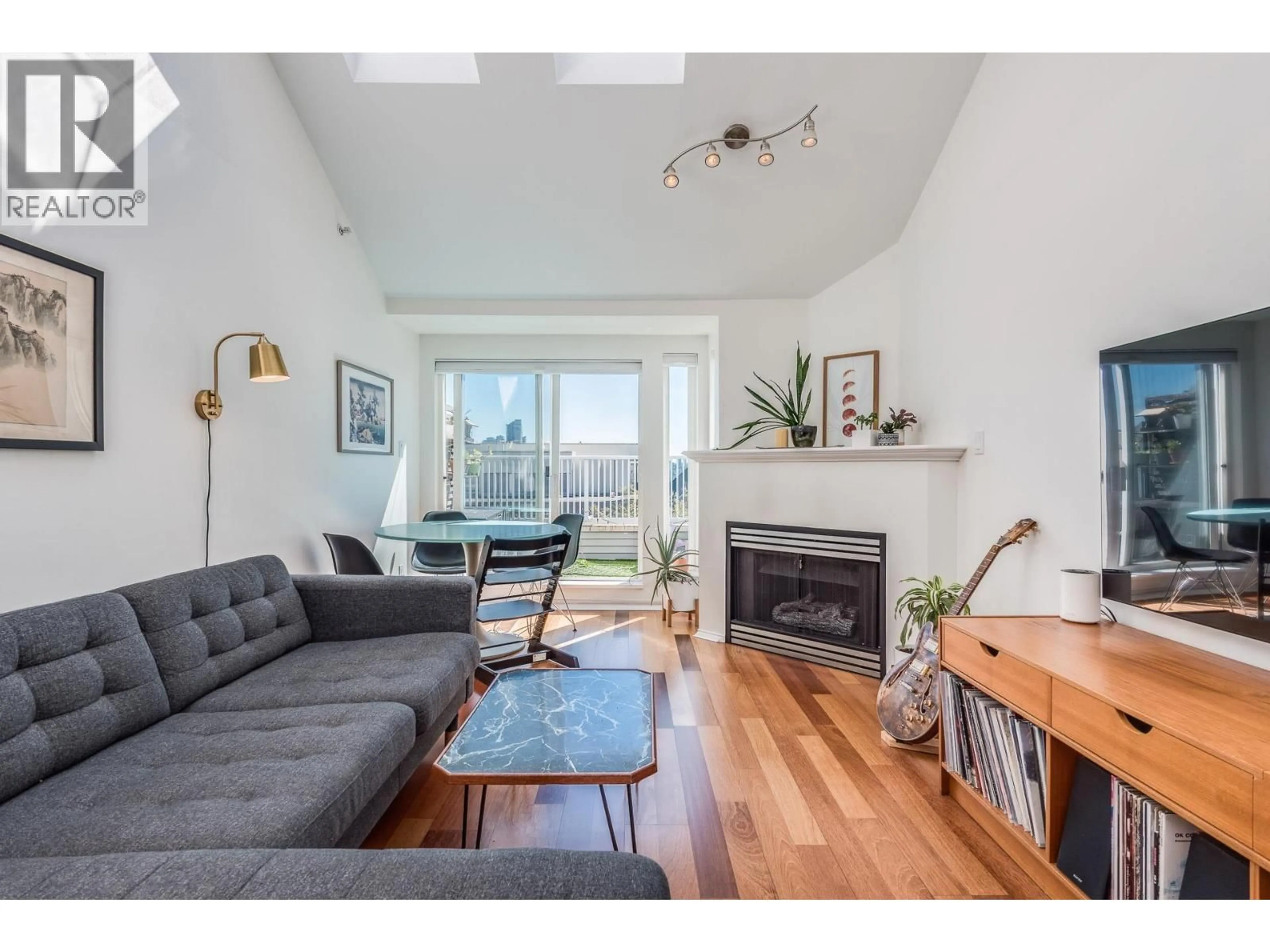 Living room with furniture, wood/laminate floor for 404 - 3939 HASTINGS STREET, Burnaby British Columbia V5C2H8