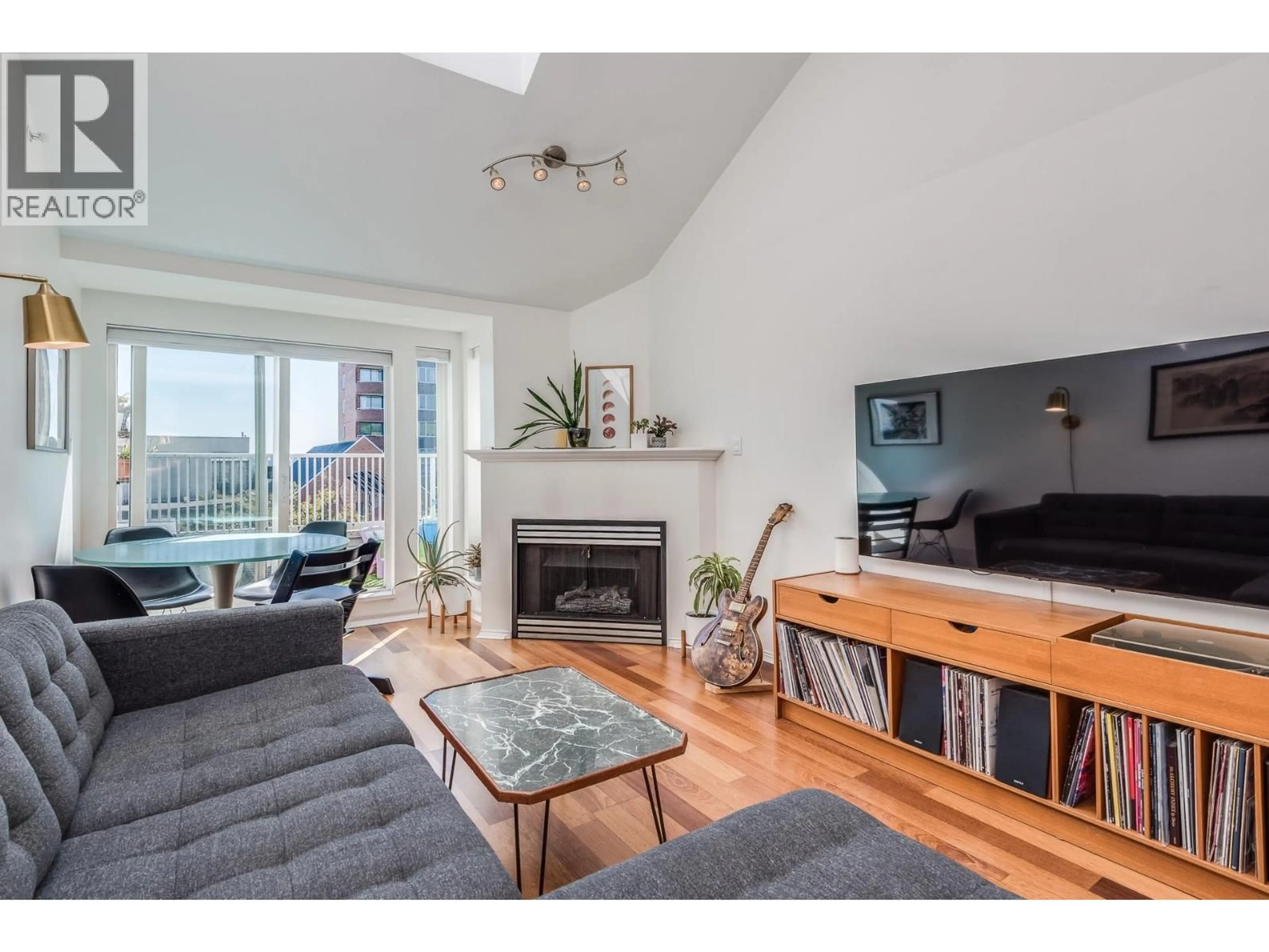 Living room with furniture, wood/laminate floor for 404 - 3939 HASTINGS STREET, Burnaby British Columbia V5C2H8