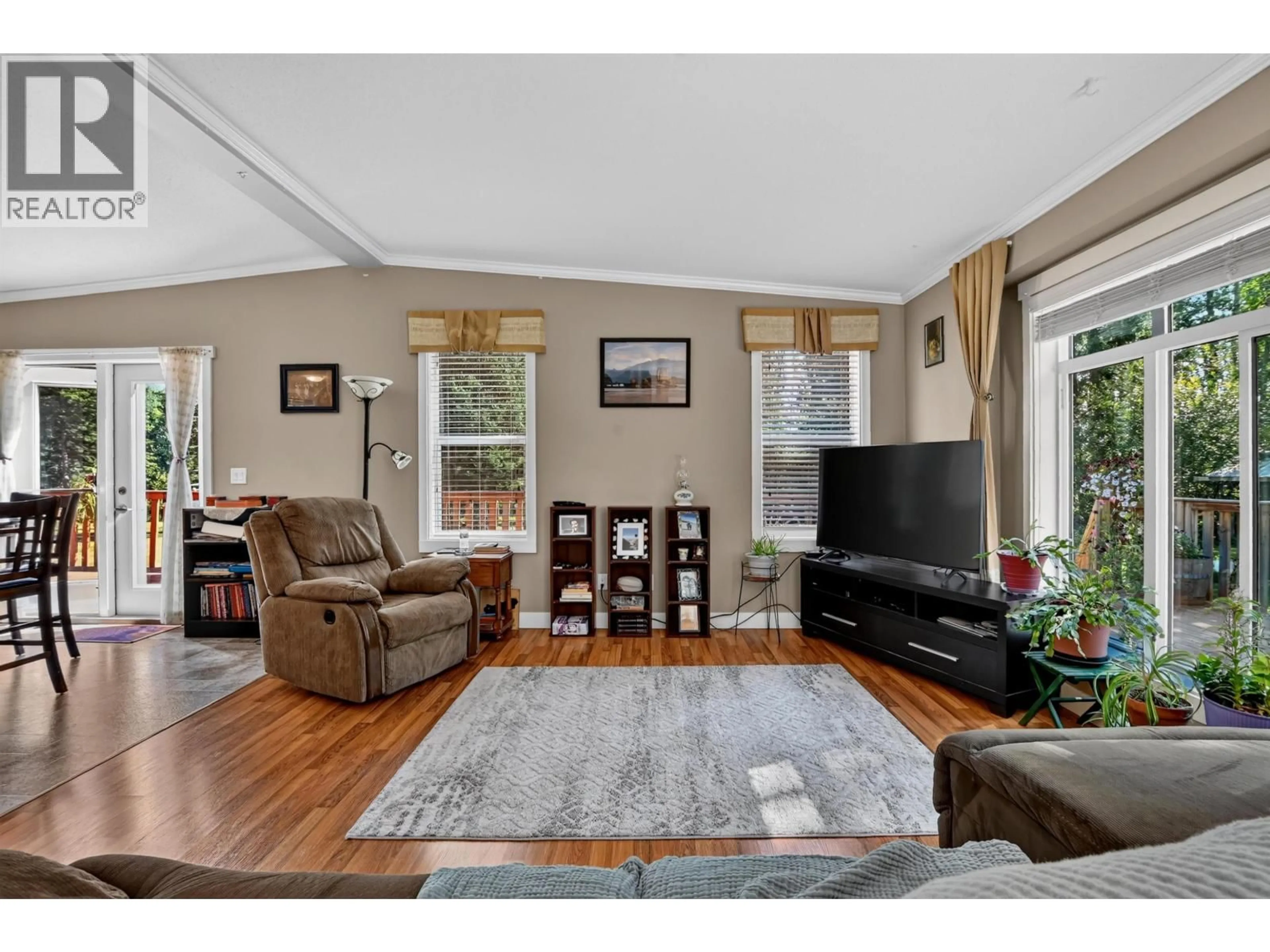 Living room with furniture, wood/laminate floor for 61730 16 HIGHWAY, Cluculz Lake British Columbia V0J3A1