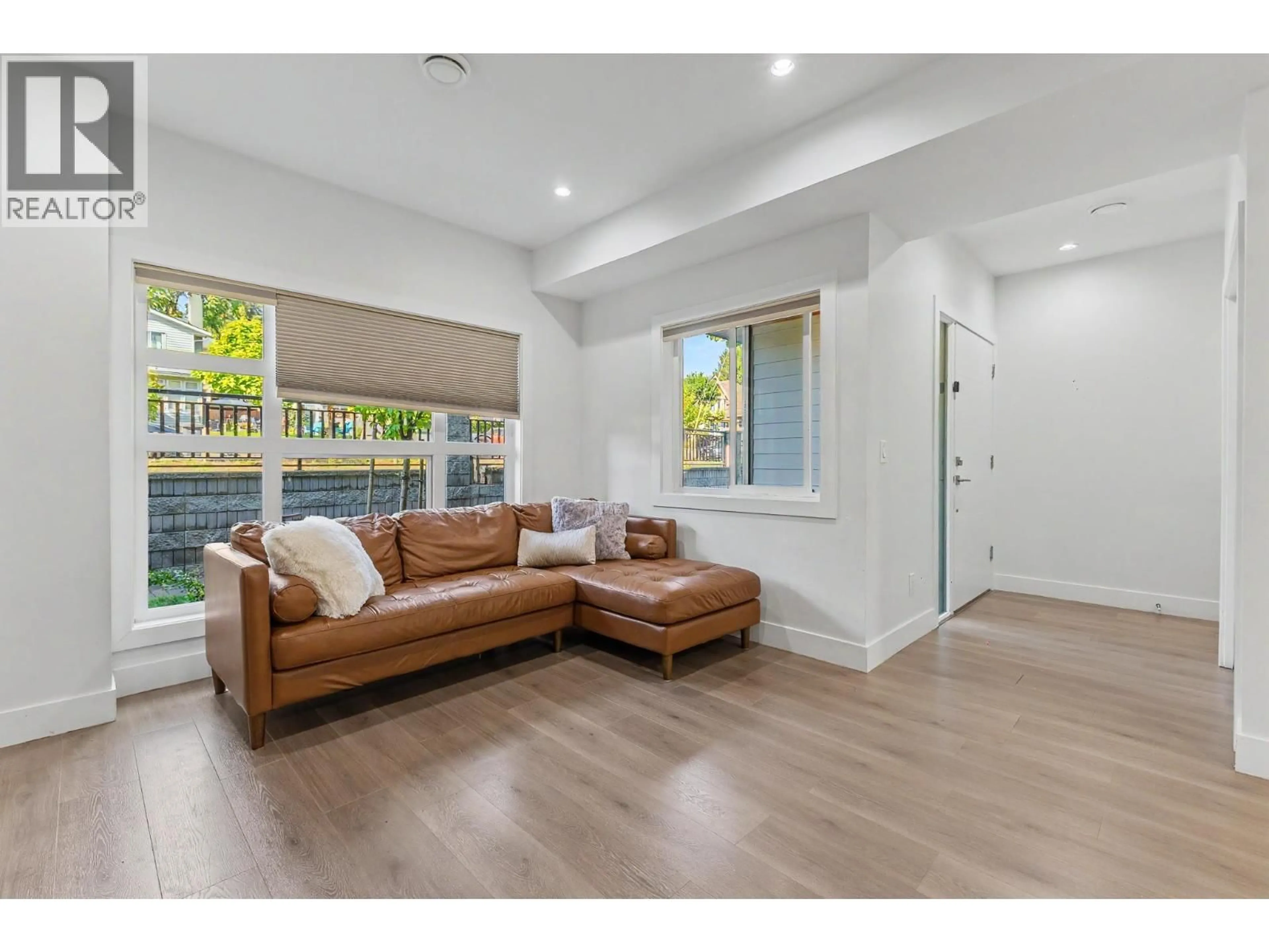 Living room with furniture, wood/laminate floor for 103 - 906 QUADLING AVENUE, Coquitlam British Columbia V3K2A5