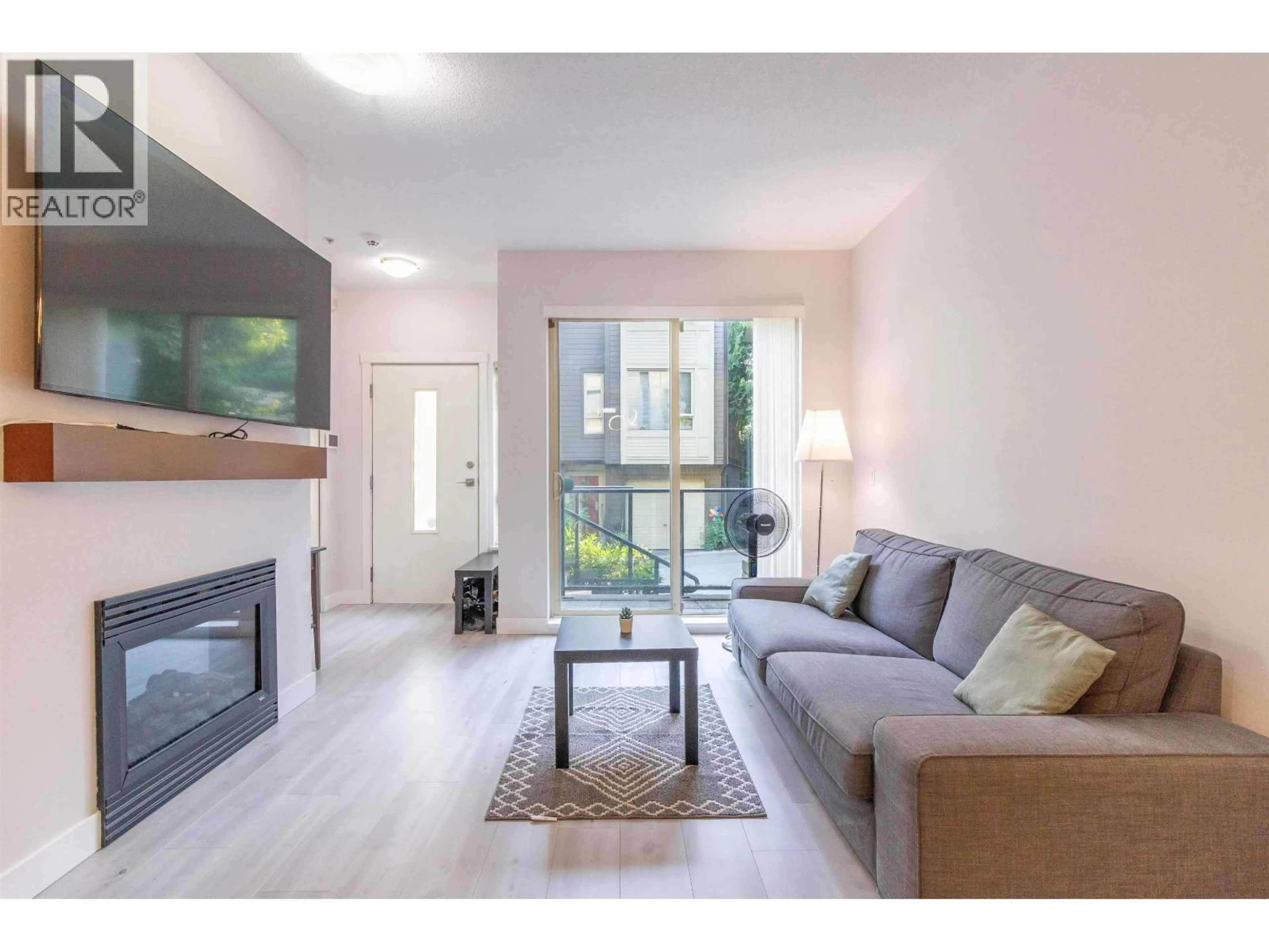 Living room with furniture, wood/laminate floor for 32 - 9229 UNIVERSITY CRESCENT, Burnaby British Columbia V5A4Z2