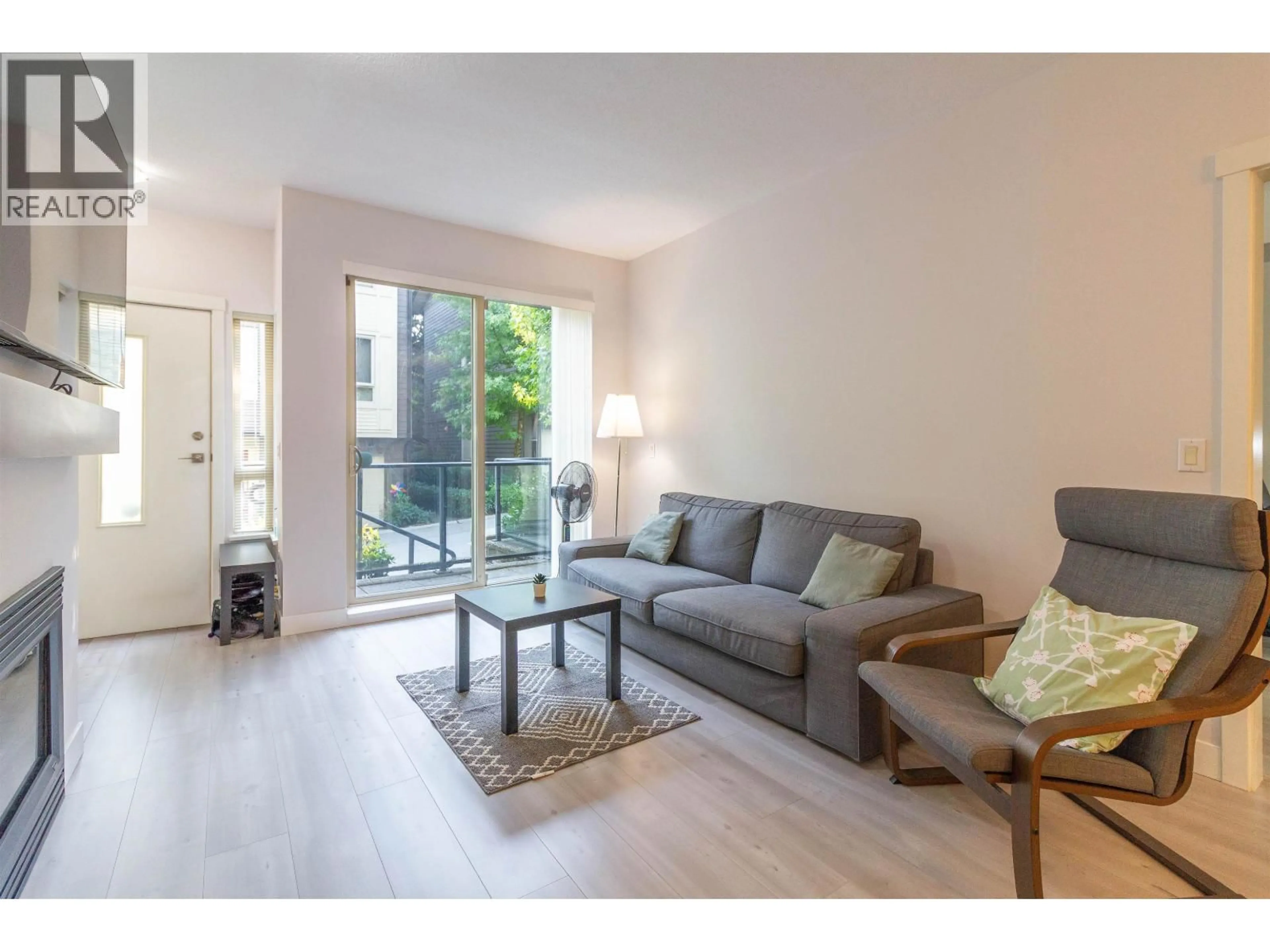 Living room with furniture, wood/laminate floor for 32 - 9229 UNIVERSITY CRESCENT, Burnaby British Columbia V5A4Z2
