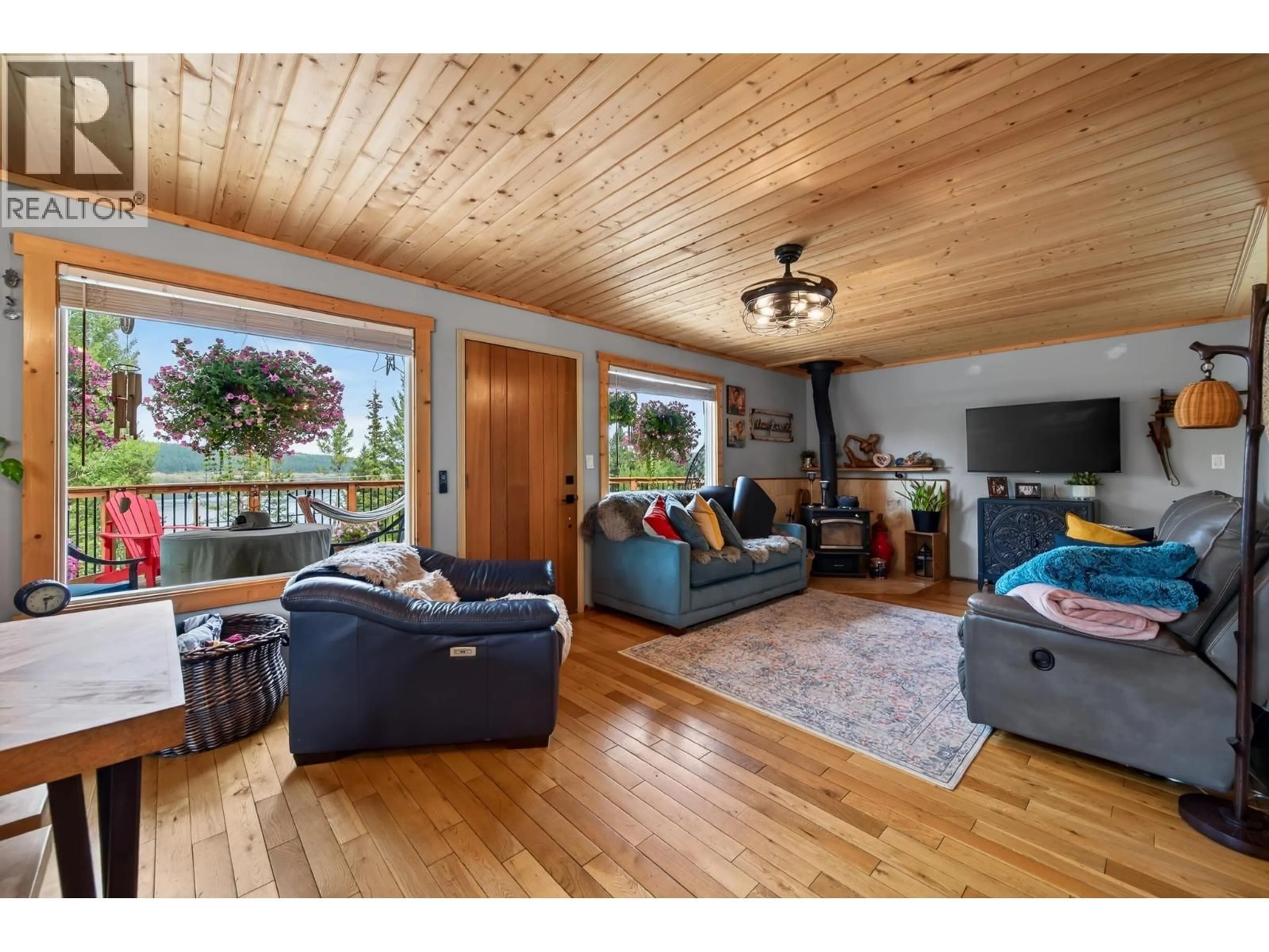 Living room with furniture, wood/laminate floor for 6294 MULLIGAN DRIVE, Horse Lake British Columbia V0K2E3