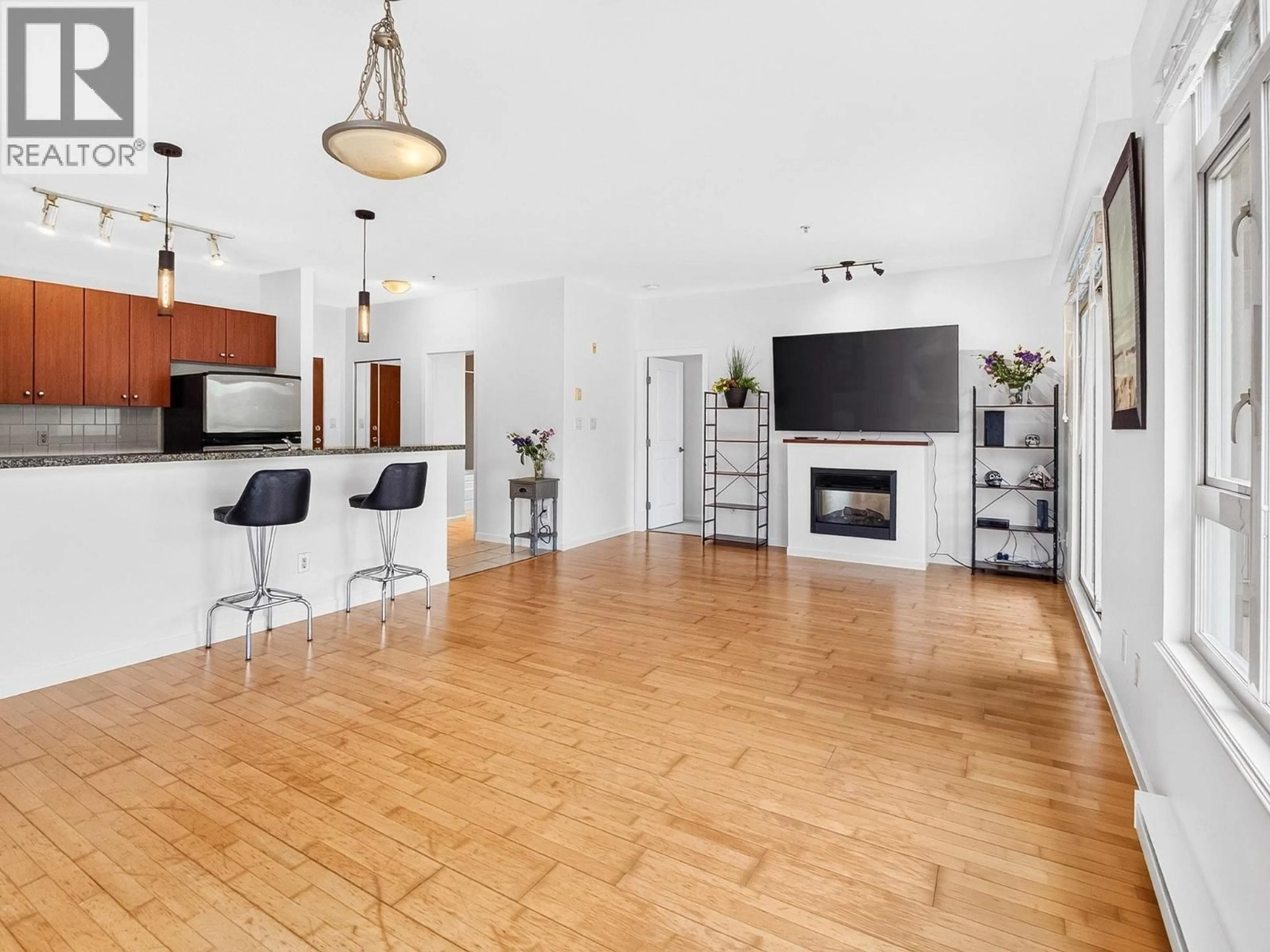 Living room with furniture, wood/laminate floor for 304 - 100 CAPILANO ROAD, Port Moody British Columbia V3H5M9