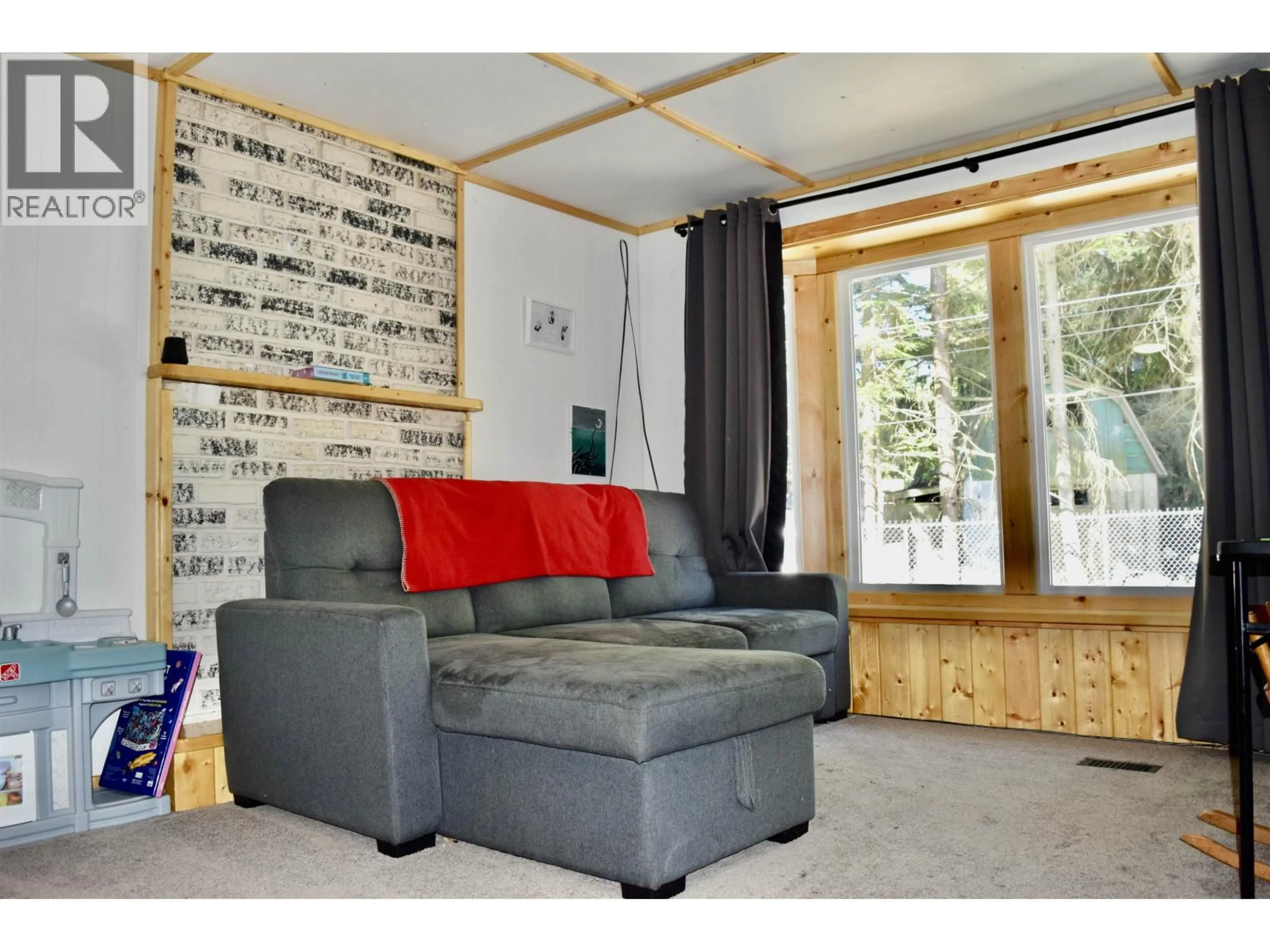 Living room with furniture, wood/laminate floor for 26 - 4619 LOWRIE AVENUE, Thornhill British Columbia V8G3X5