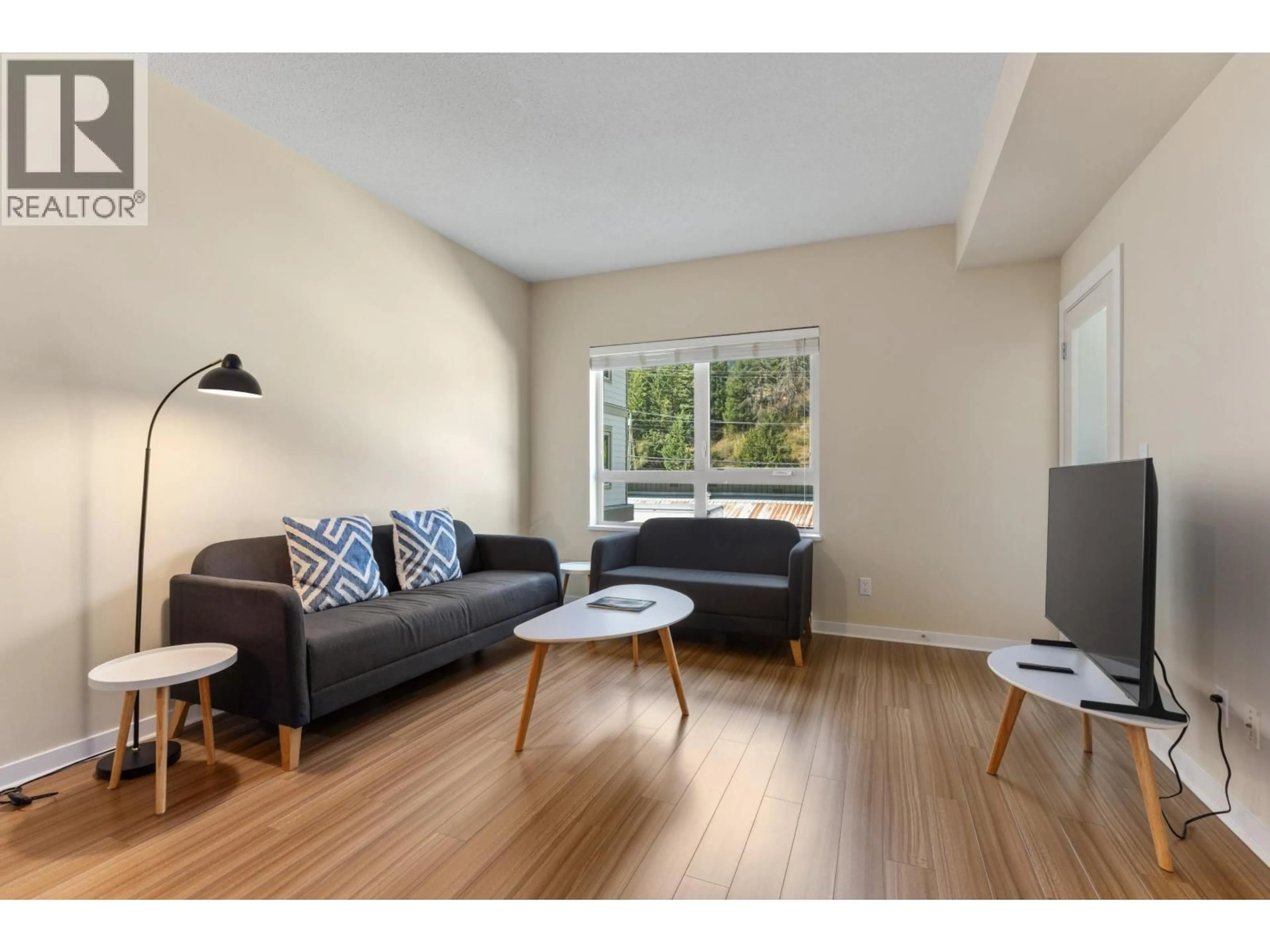 Living room with furniture, wood/laminate floor for 202 - 7445 FRONTIER STREET, Pemberton British Columbia V0N2L1