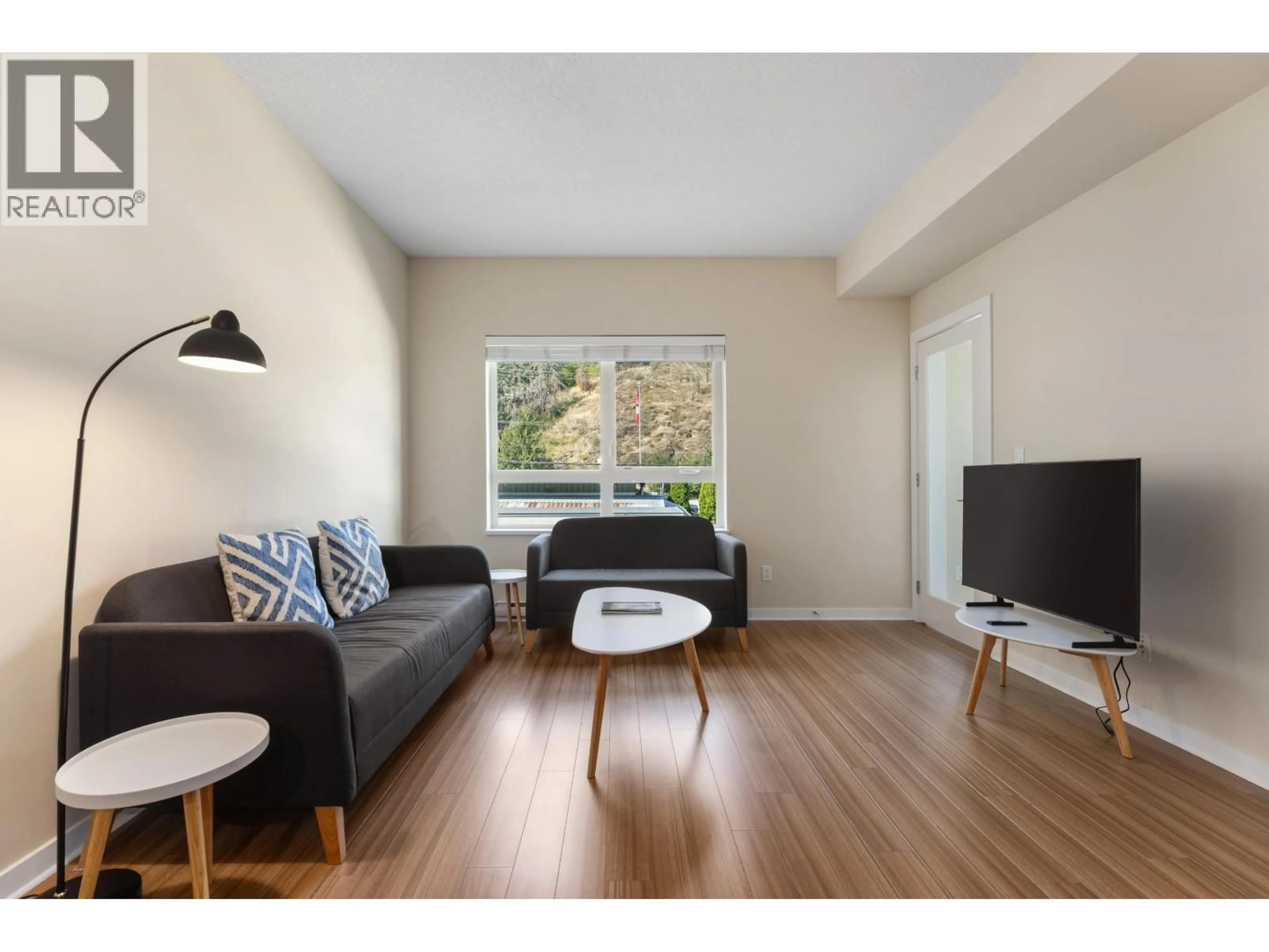 Living room with furniture, wood/laminate floor for 202 - 7445 FRONTIER STREET, Pemberton British Columbia V0N2L1
