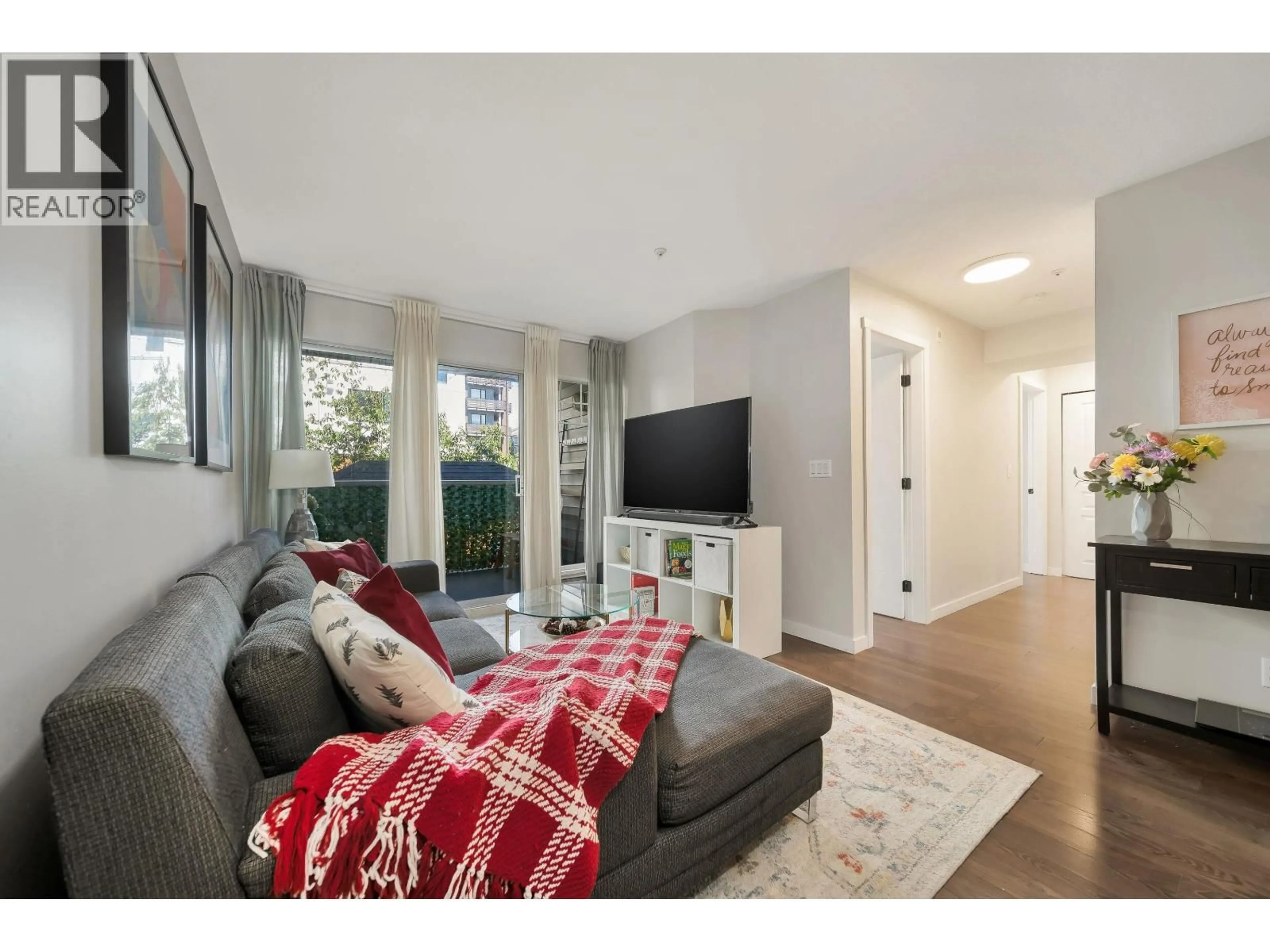 Living room with furniture, wood/laminate floor for 204 - 11671 FRASER STREET, Maple Ridge British Columbia V2X6C4