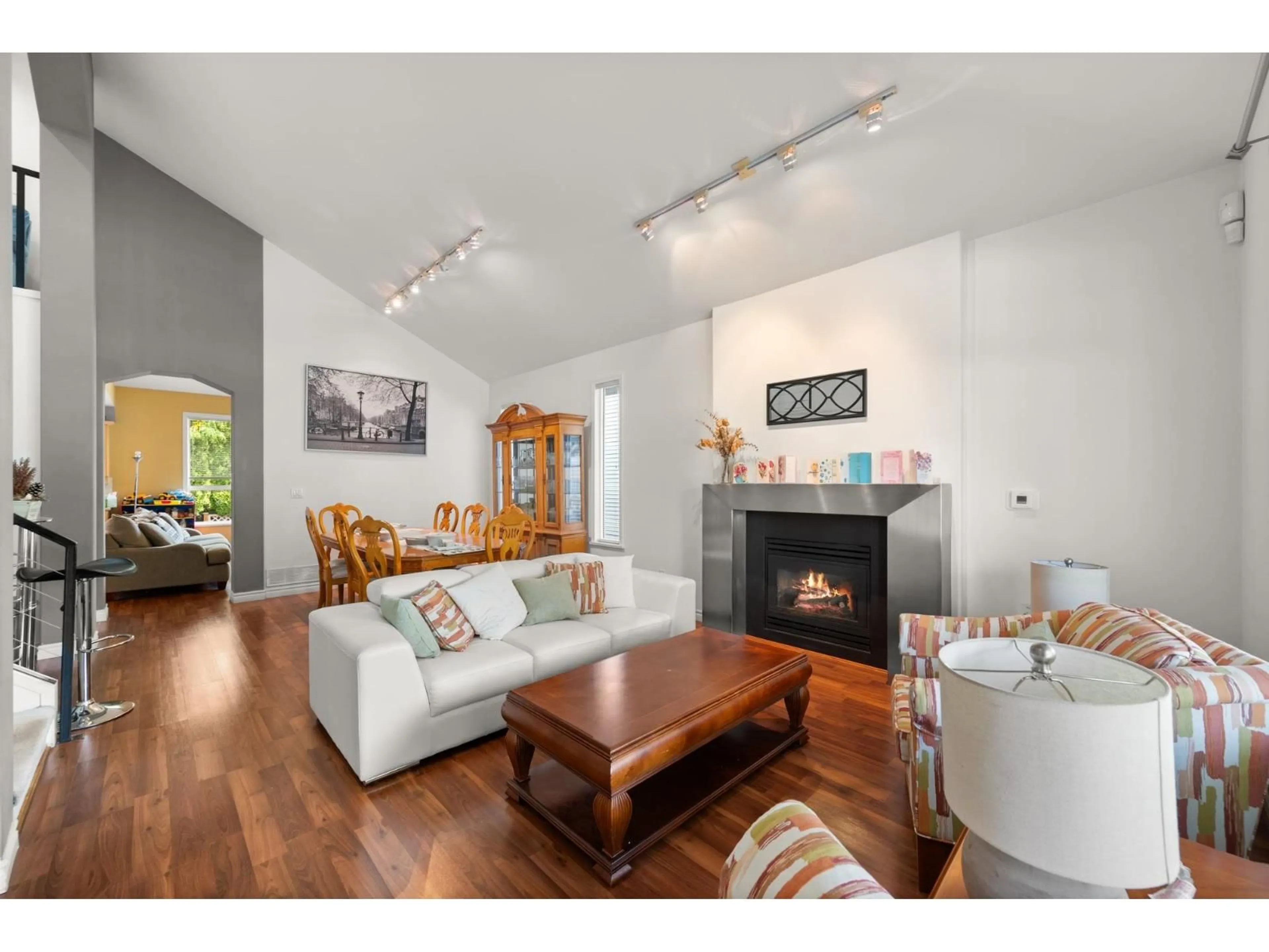 Living room with furniture, wood/laminate floor for 7530 146 STREET, Surrey British Columbia V3S8T9