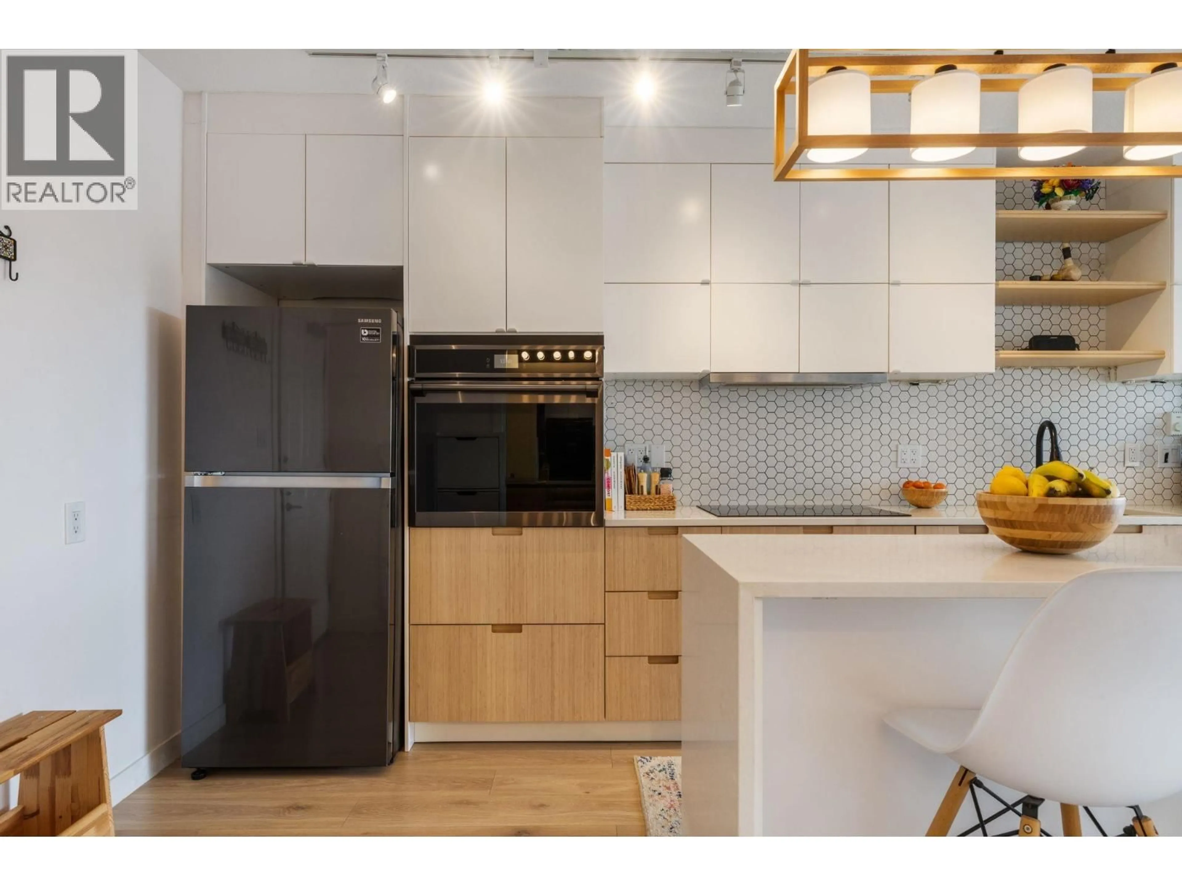 Open concept kitchen, wood/laminate floor for PH10 - 702 KING EDWARD AVENUE, Vancouver British Columbia V5V0A9