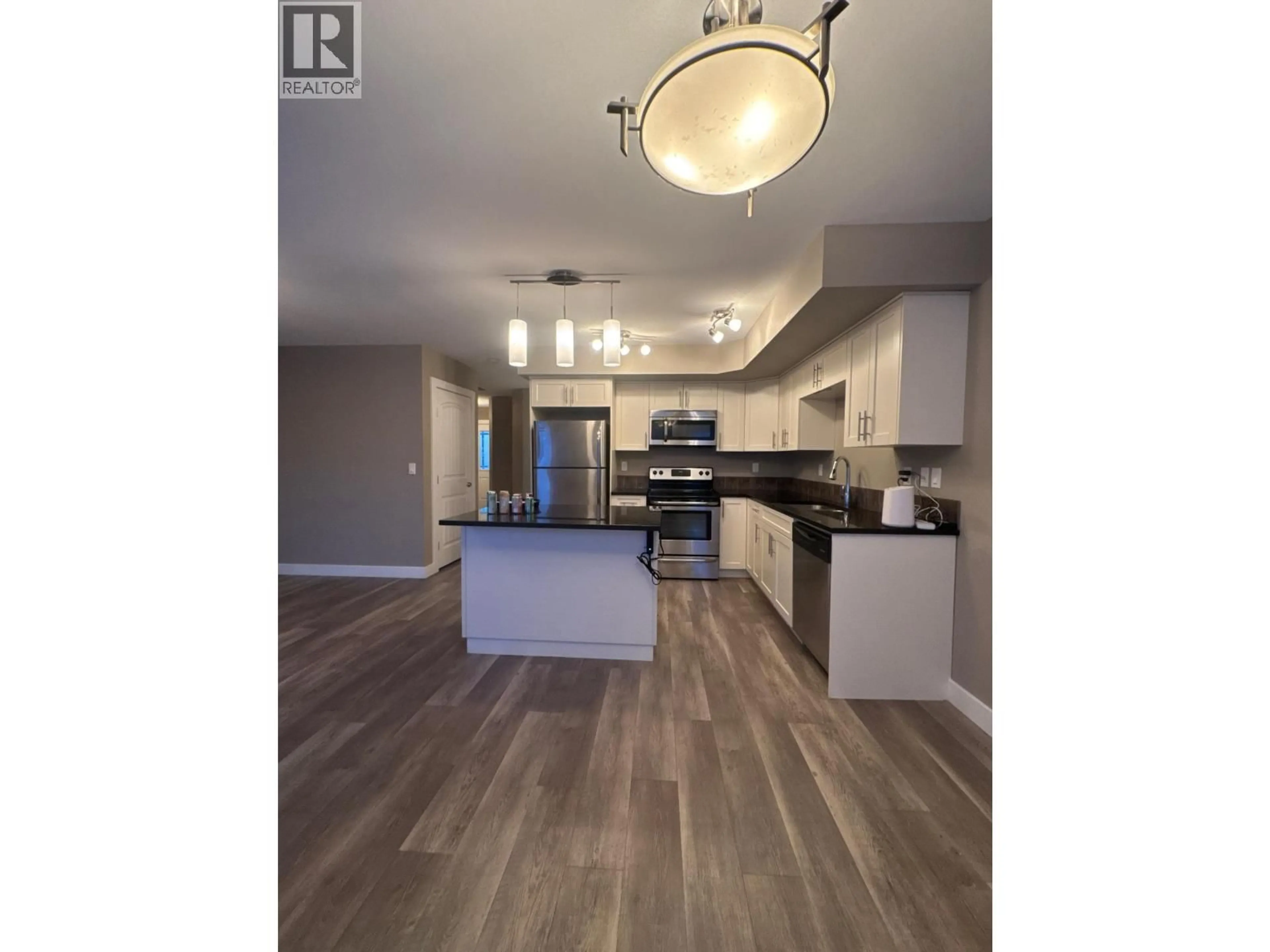 Open concept kitchen, wood/laminate floor for 138 - 10104 114A AVENUE, Fort St. John British Columbia V1J8K6