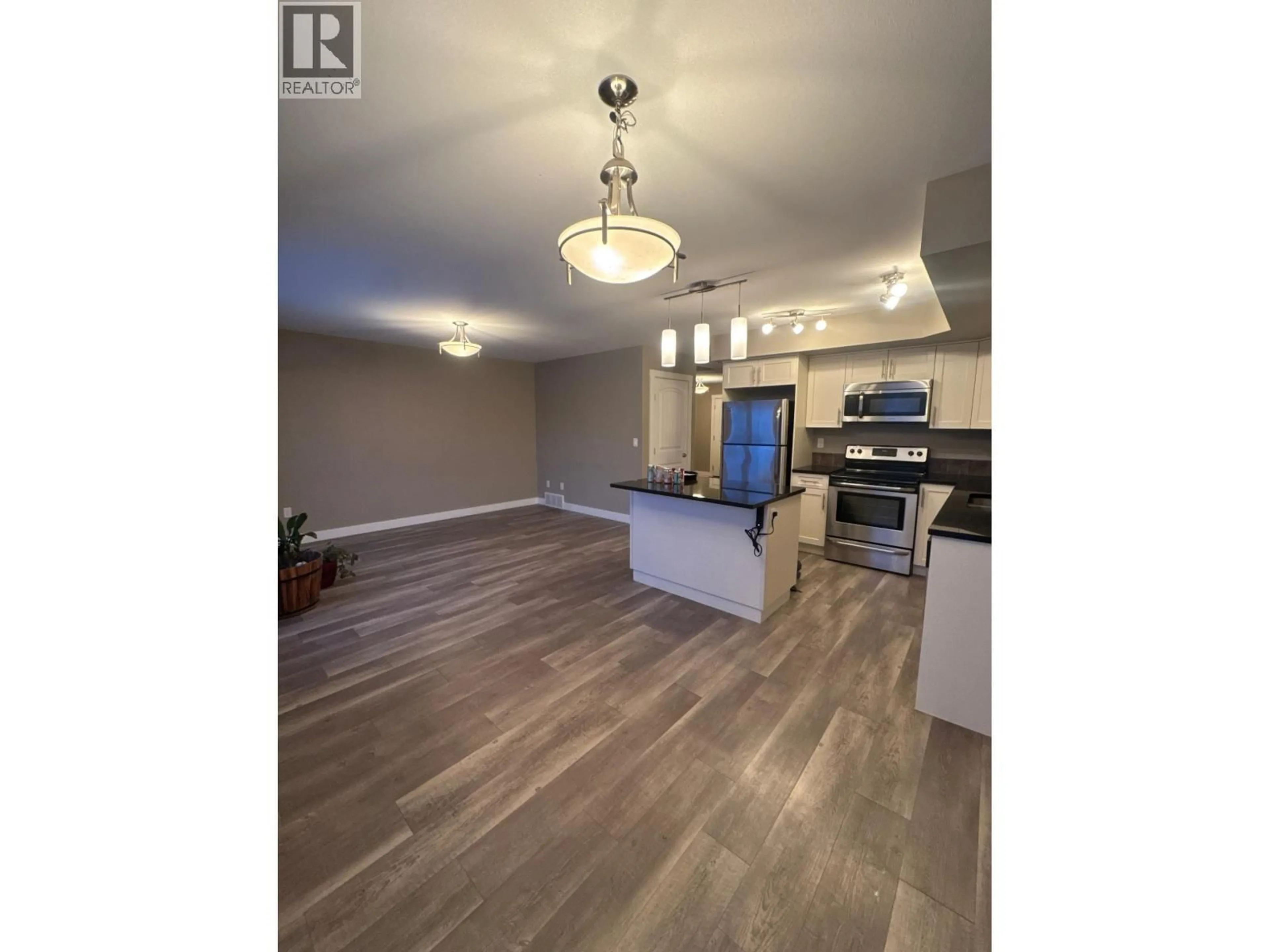 Open concept kitchen, wood/laminate floor for 138 - 10104 114A AVENUE, Fort St. John British Columbia V1J8K6