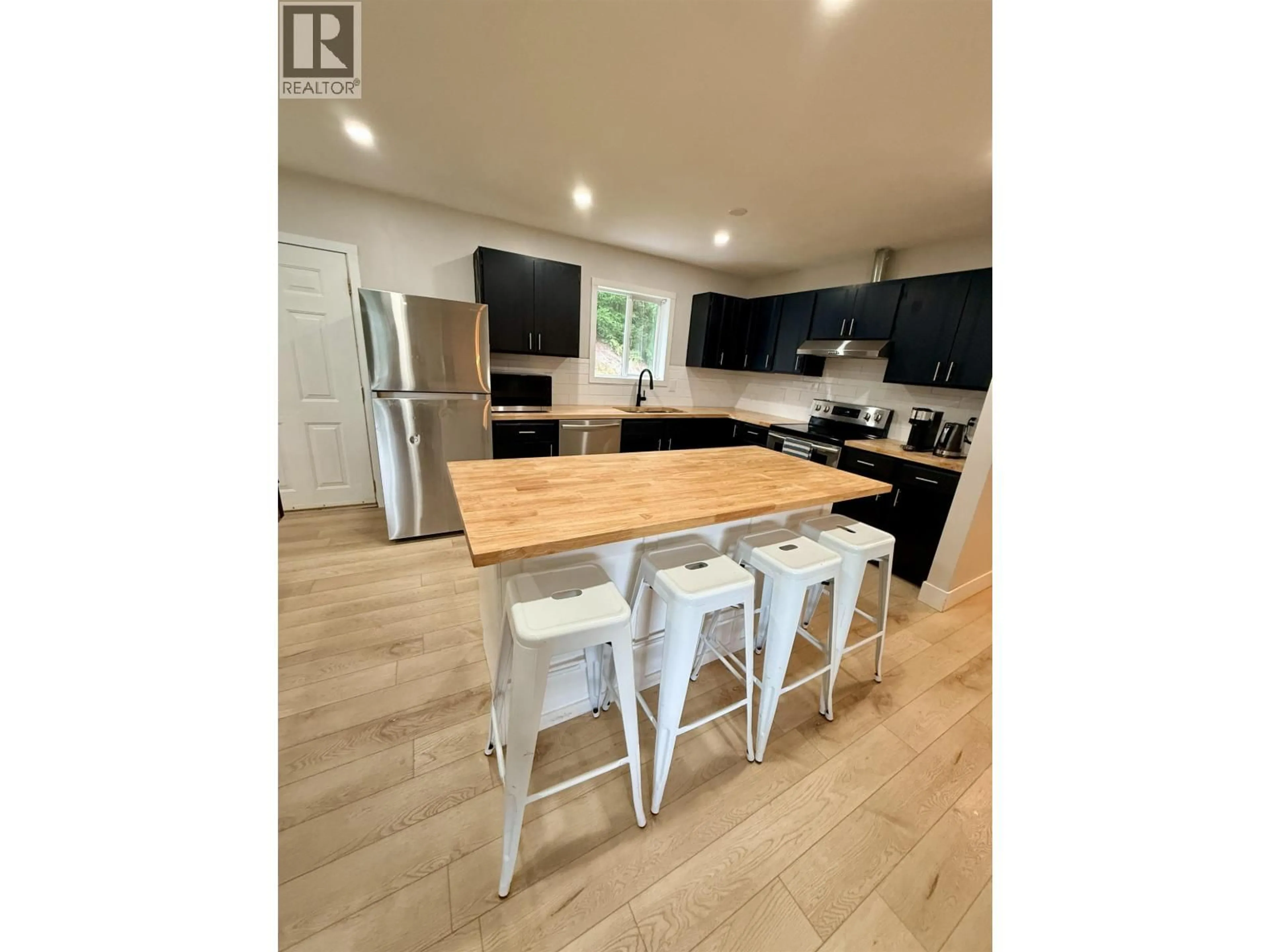 Open concept kitchen, wood/laminate floor for 6024 KIM PLACE, Prince George British Columbia V2K3L7