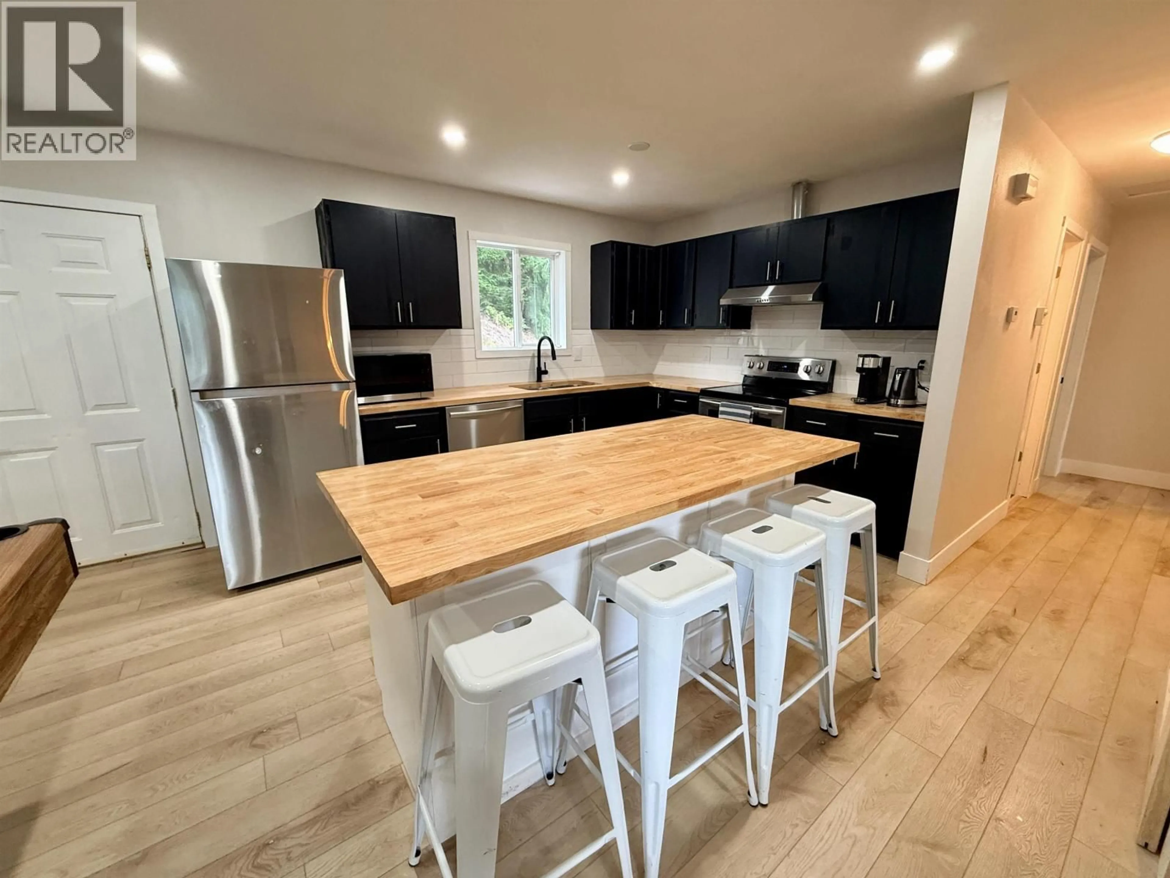 Open concept kitchen, wood/laminate floor for 6024 KIM PLACE, Prince George British Columbia V2K3L7