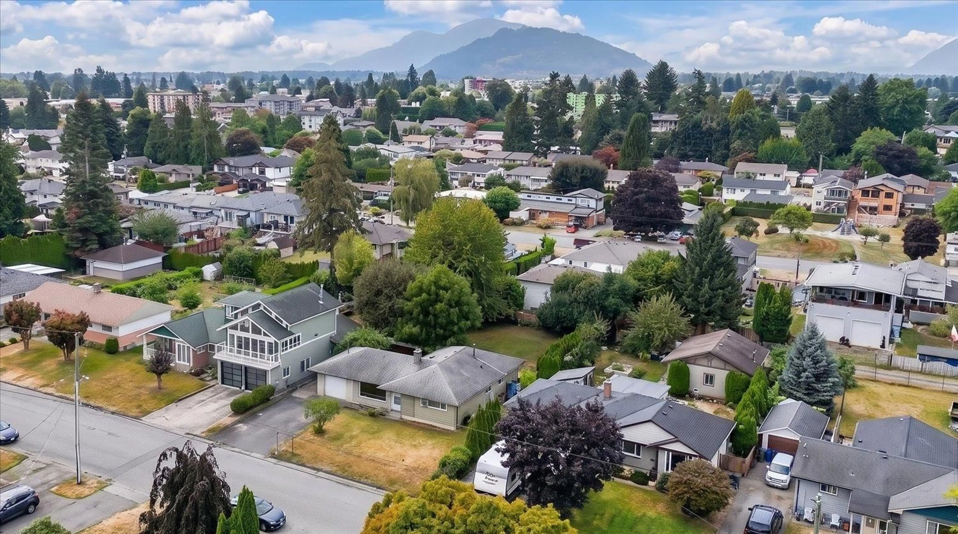 A pic from outside/outdoor area/front of a property/back of a property/a pic from drone, mountain view for 9647 WINDSOR STREET, Chilliwack British Columbia V2P6C3