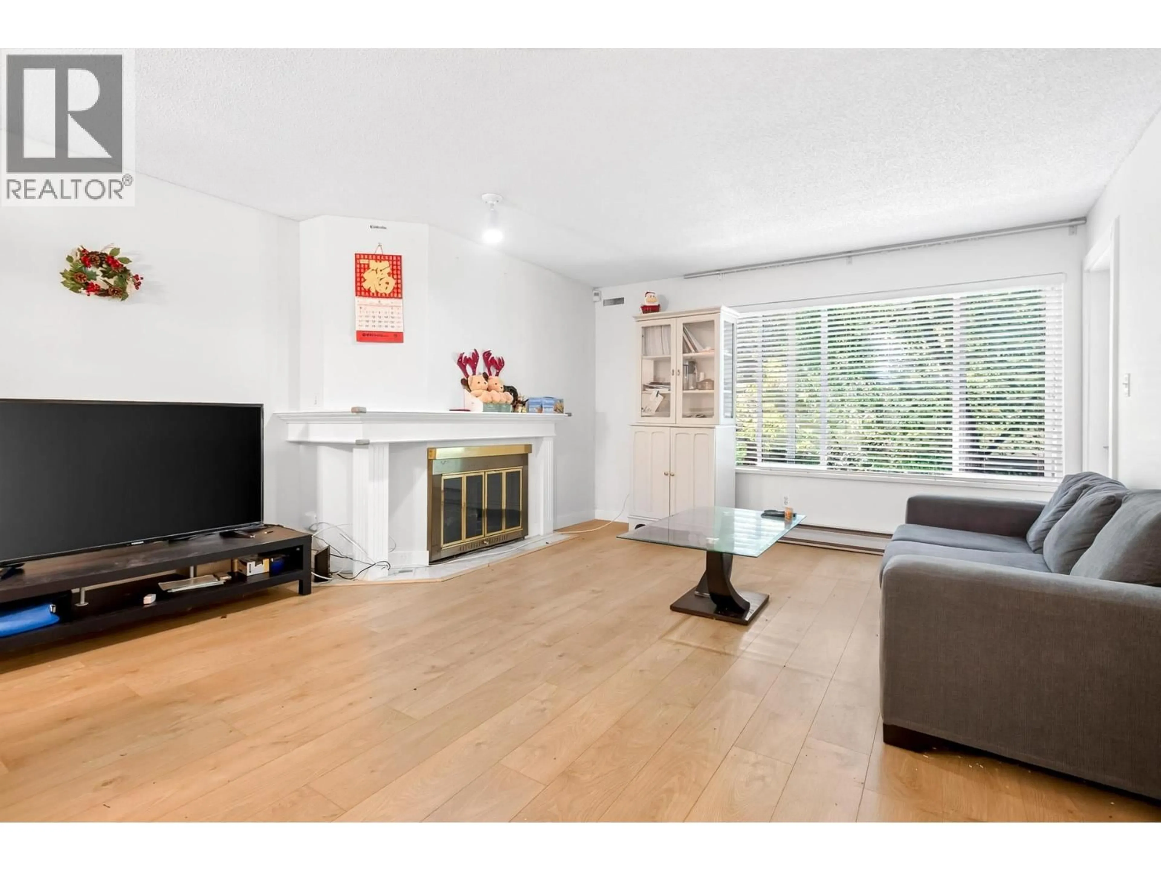 Living room with furniture, wood/laminate floor for 104 - 7560 MOFFATT ROAD, Richmond British Columbia V6Y1X8