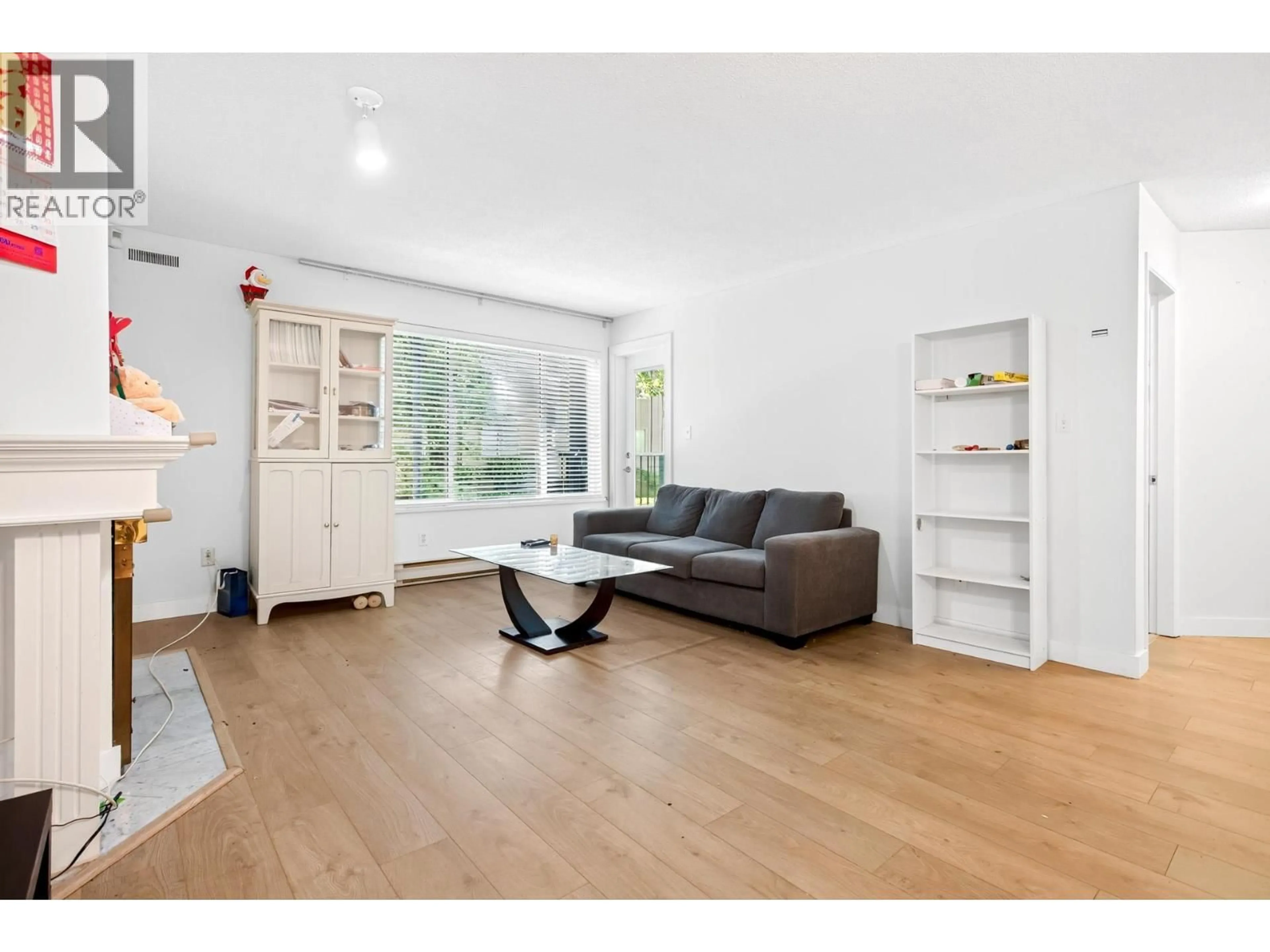 Living room with furniture, wood/laminate floor for 104 - 7560 MOFFATT ROAD, Richmond British Columbia V6Y1X8