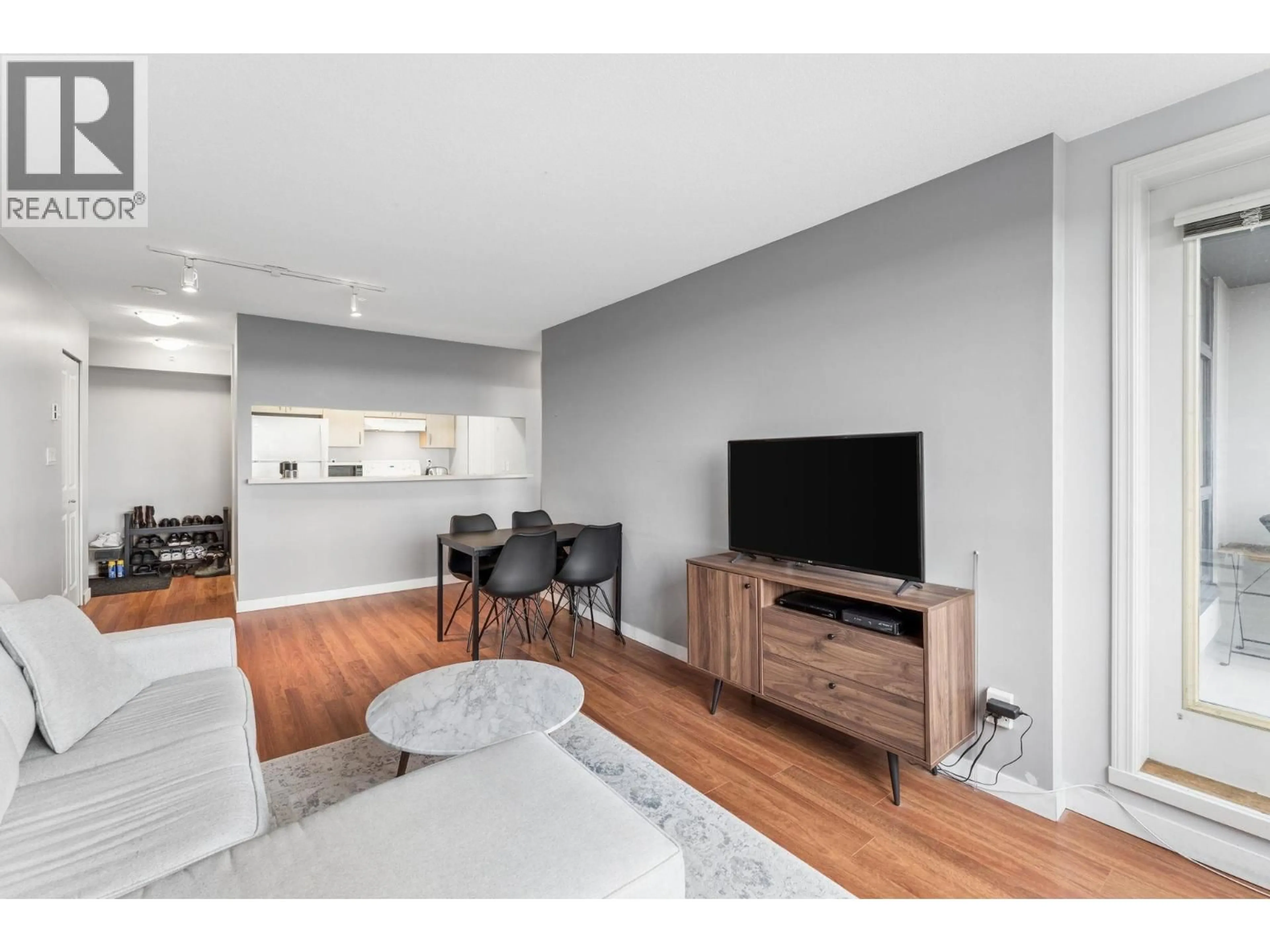 Living room with furniture, wood/laminate floor for 901 - 3520 CROWLEY DRIVE, Vancouver British Columbia V5R6G9