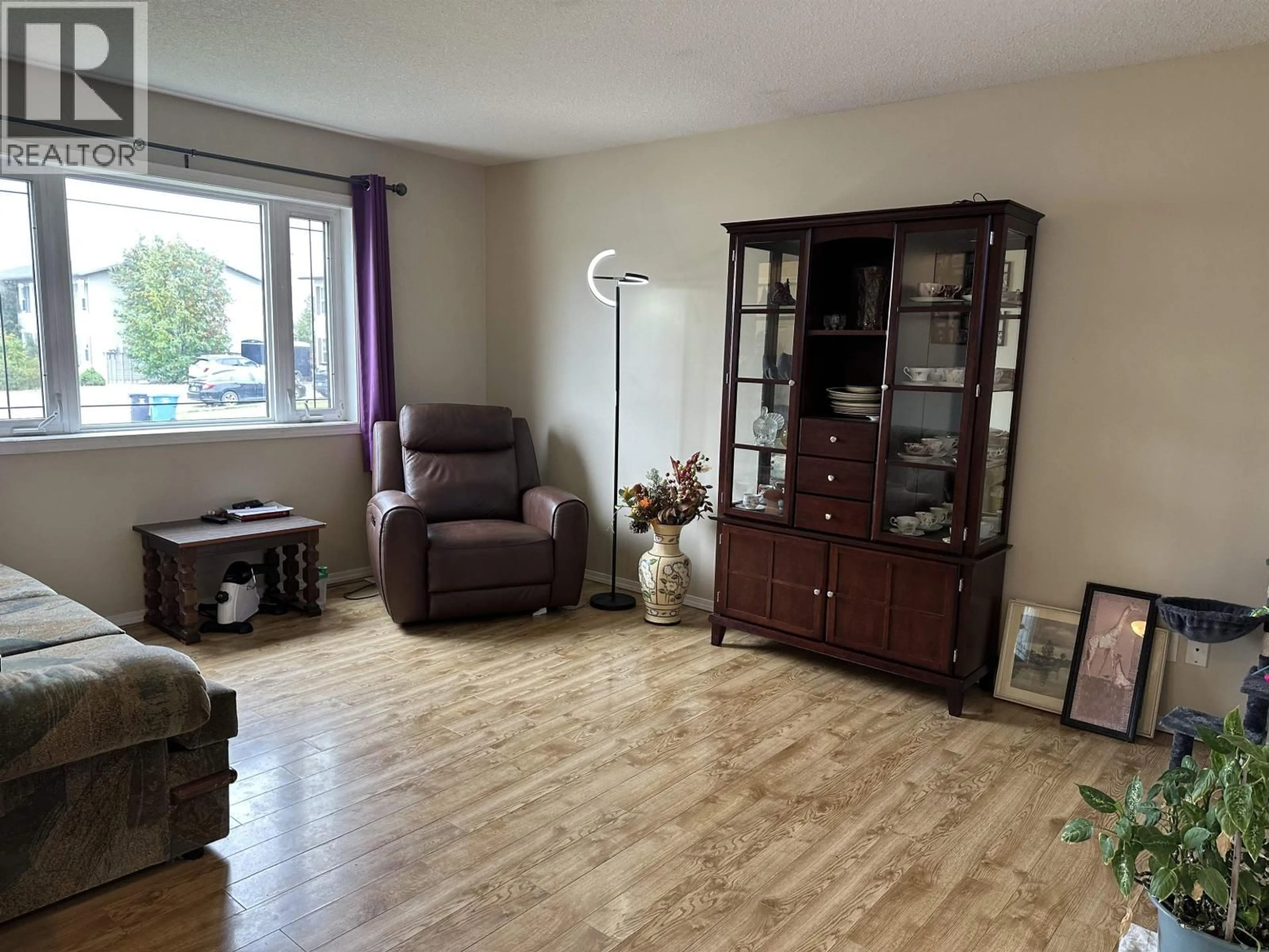 Living room with furniture, wood/laminate floor for 8728 81A STREET, Fort St. John British Columbia V1J0B5