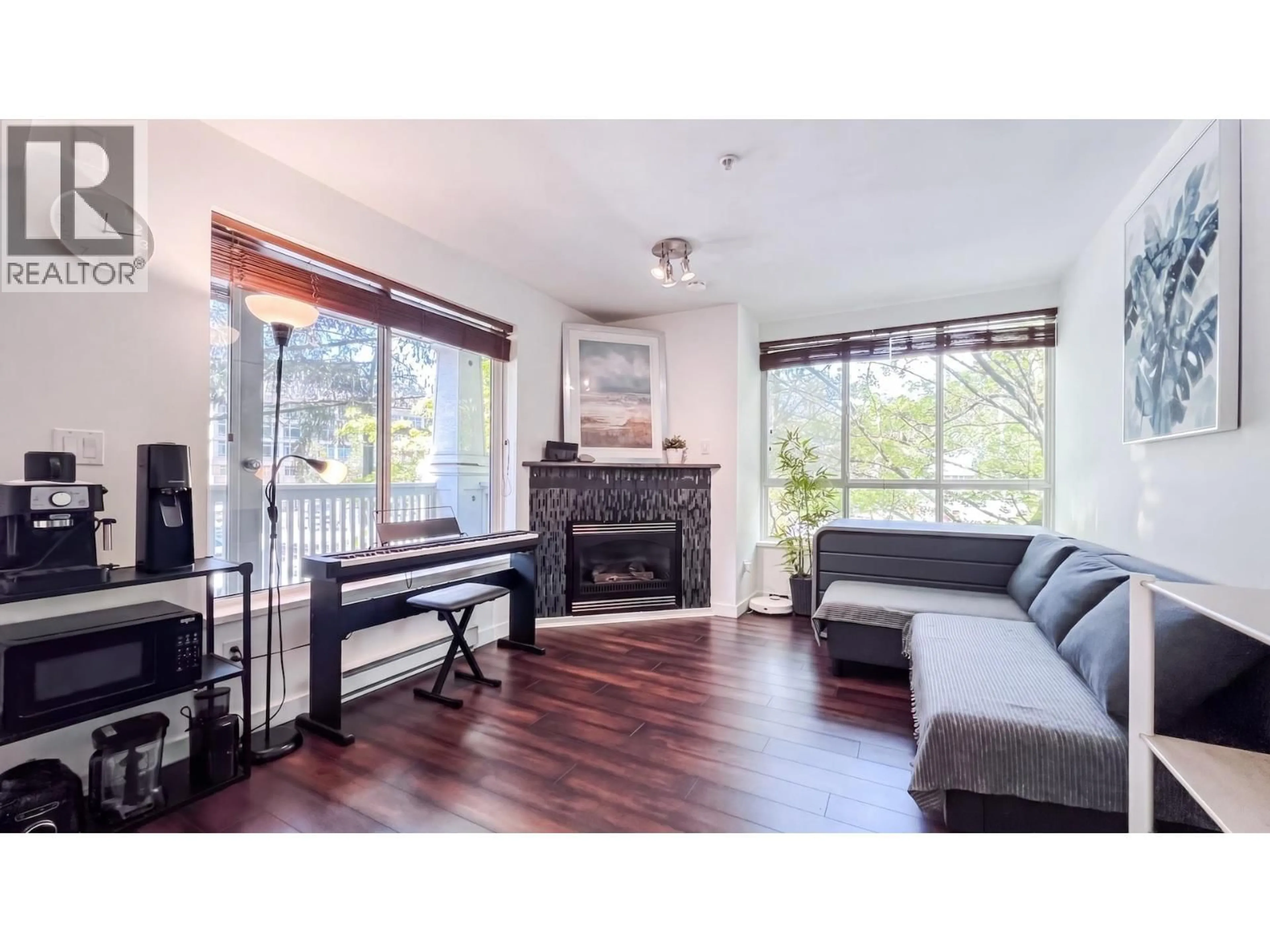 Living room with furniture, wood/laminate floor for 306 - 1111 LYNN VALLEY ROAD, North Vancouver British Columbia V7J3V4