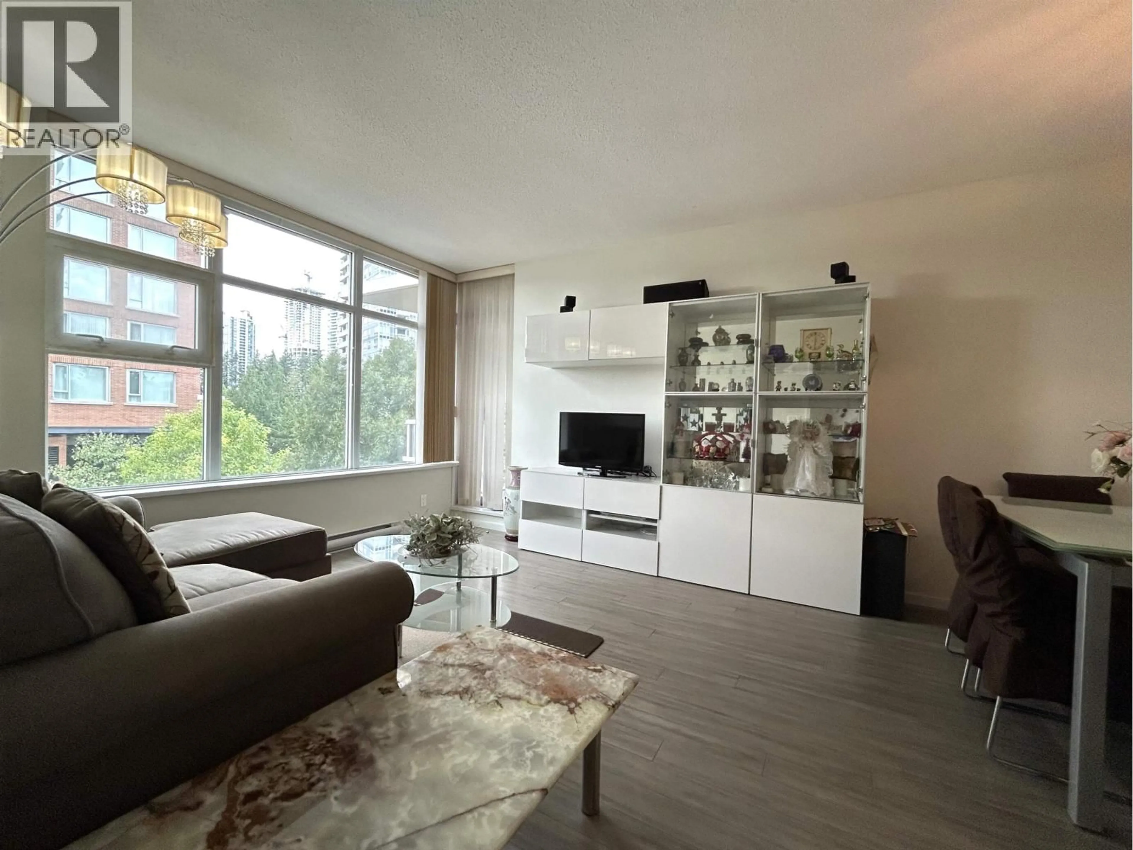 Living room with furniture, wood/laminate floor for 307 - 3102 WINDSOR GATE, Coquitlam British Columbia V3B0J3