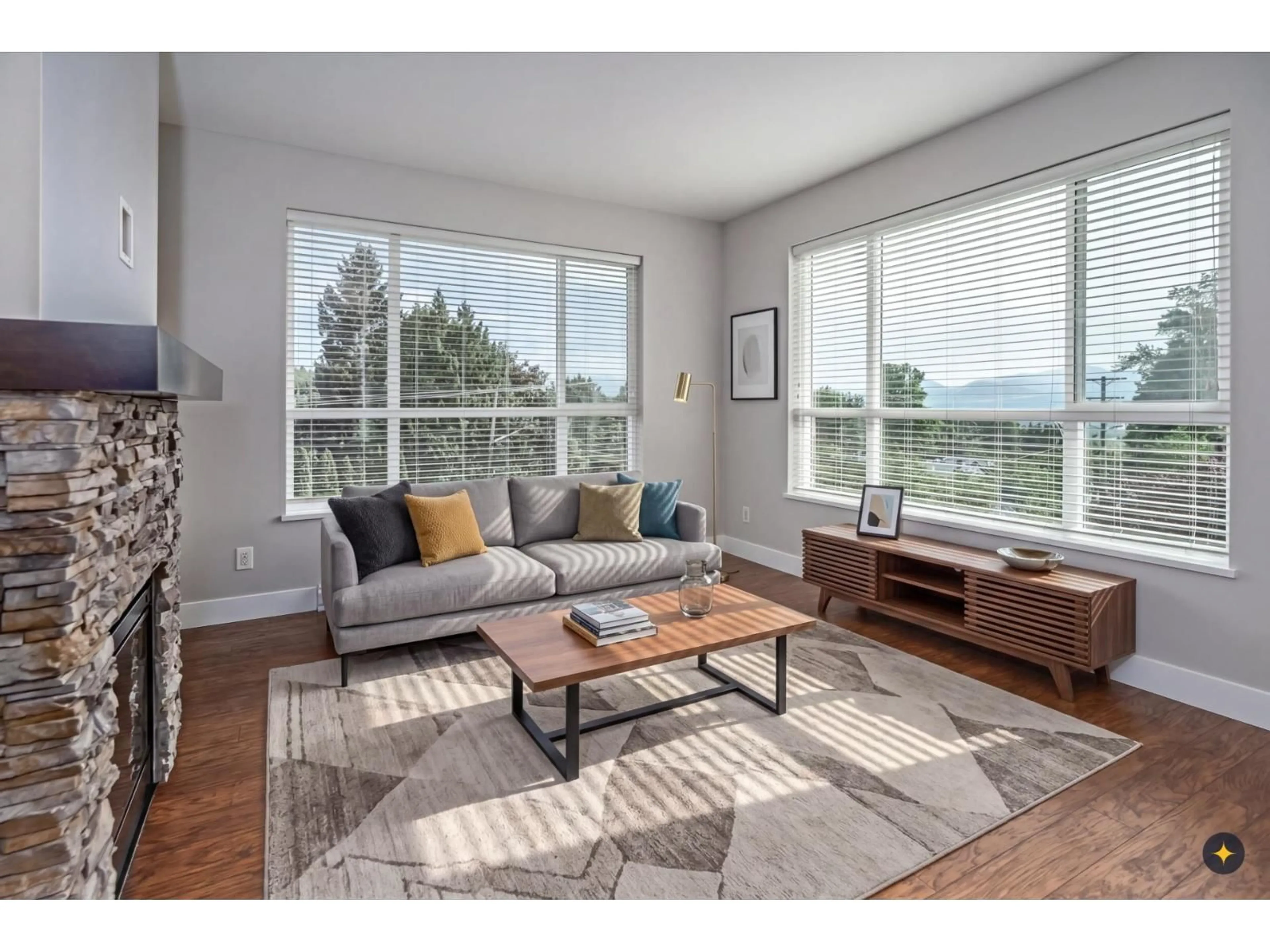 Living room with furniture, wood/laminate floor for 303 - 3192 GLADWIN ROAD, Abbotsford British Columbia V2T6M9