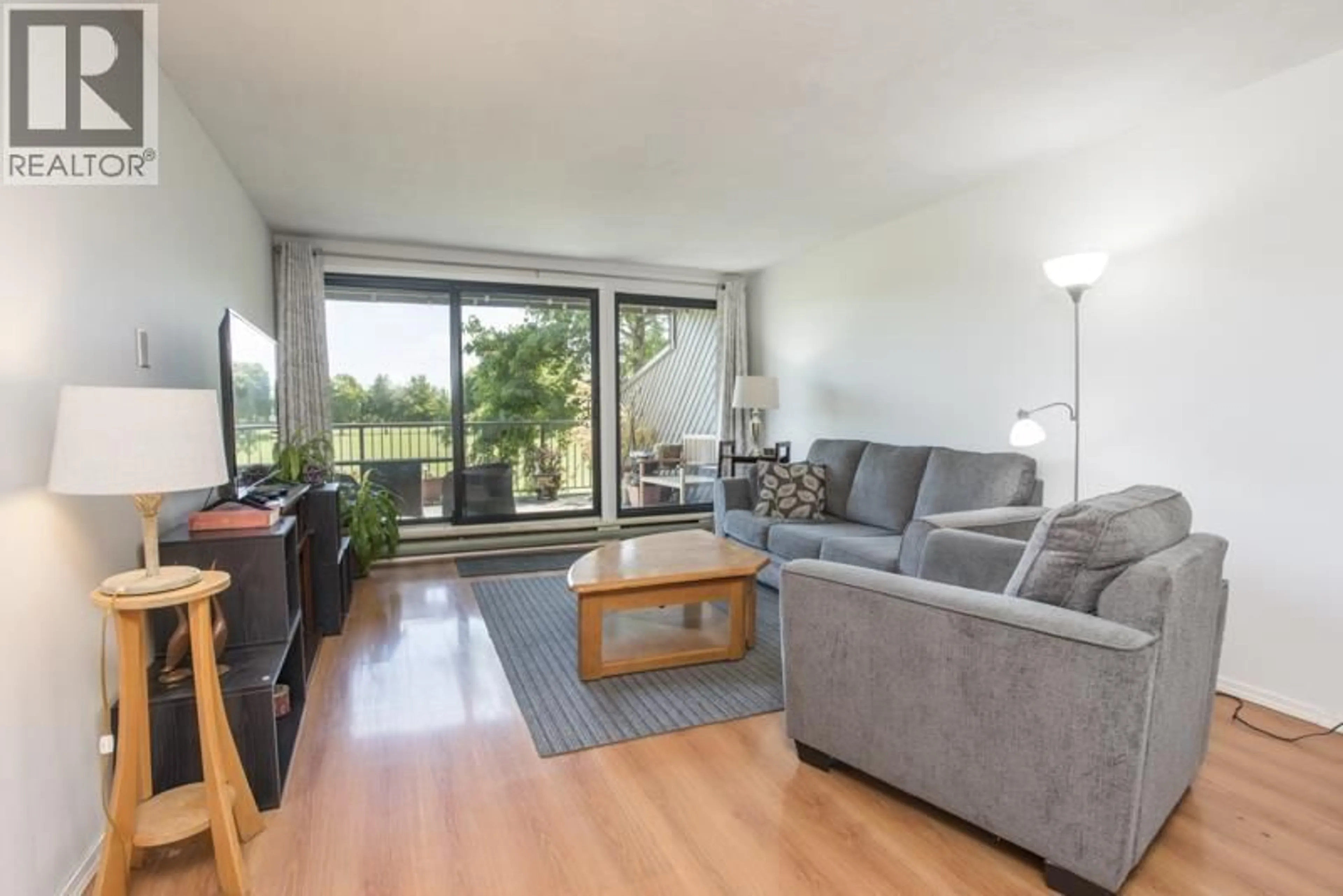 Living room with furniture, wood/laminate floor for 115 - 9300 GLENACRES DRIVE, Richmond British Columbia V7A1Y8