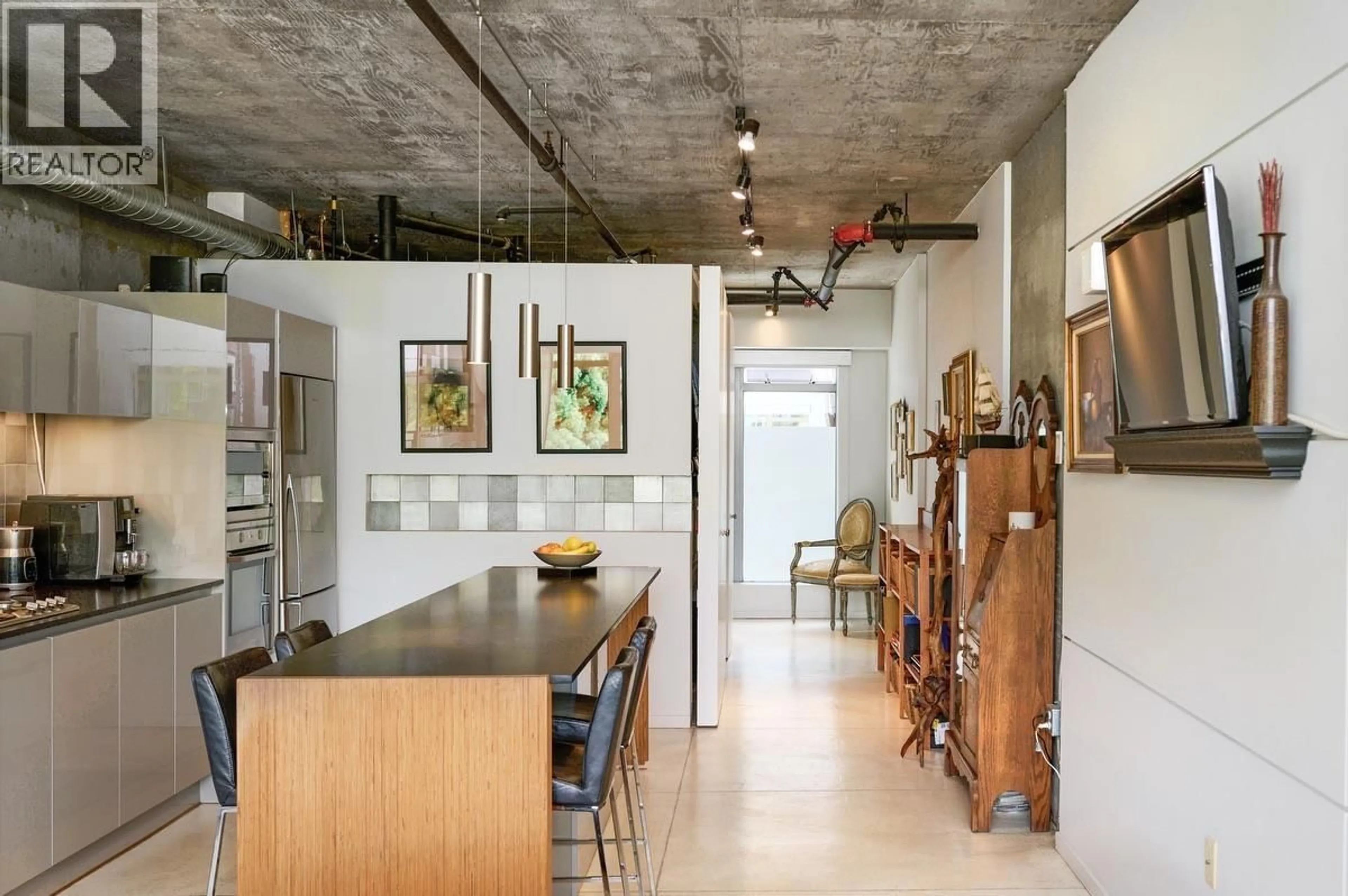 Open concept kitchen, cement floor for 205 - 1529 6TH AVENUE, Vancouver British Columbia V6J1R1