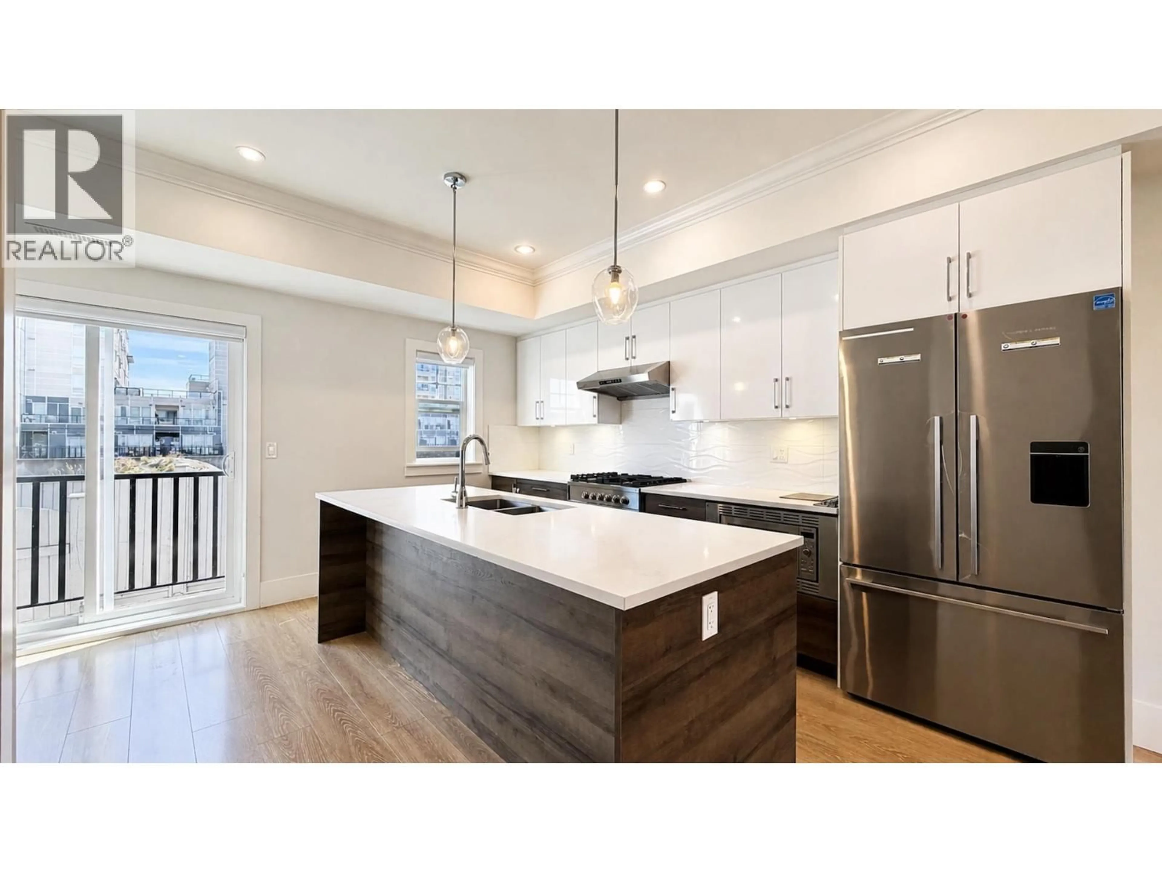 Open concept kitchen, wood/laminate floor for 12 - 9211 MCKIM WAY, Richmond British Columbia V6X0T1