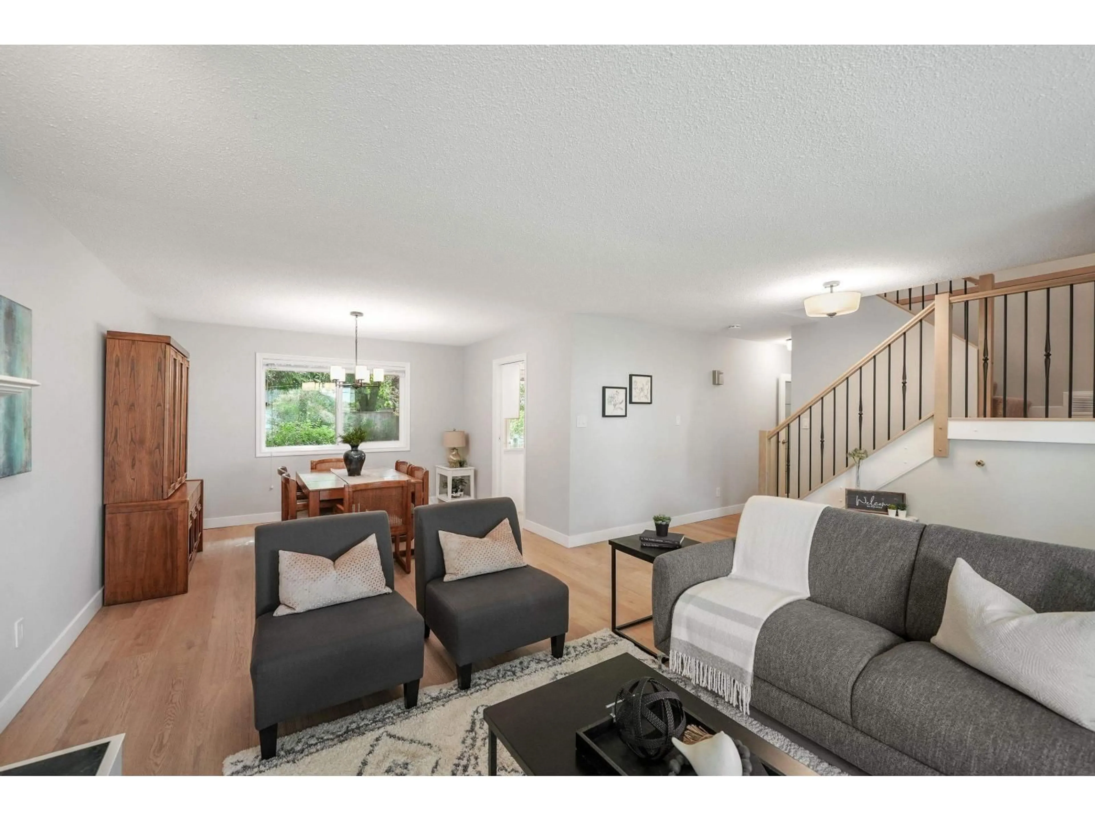 Living room with furniture, wood/laminate floor for 18096 61A AVENUE, Surrey British Columbia V3S5V8