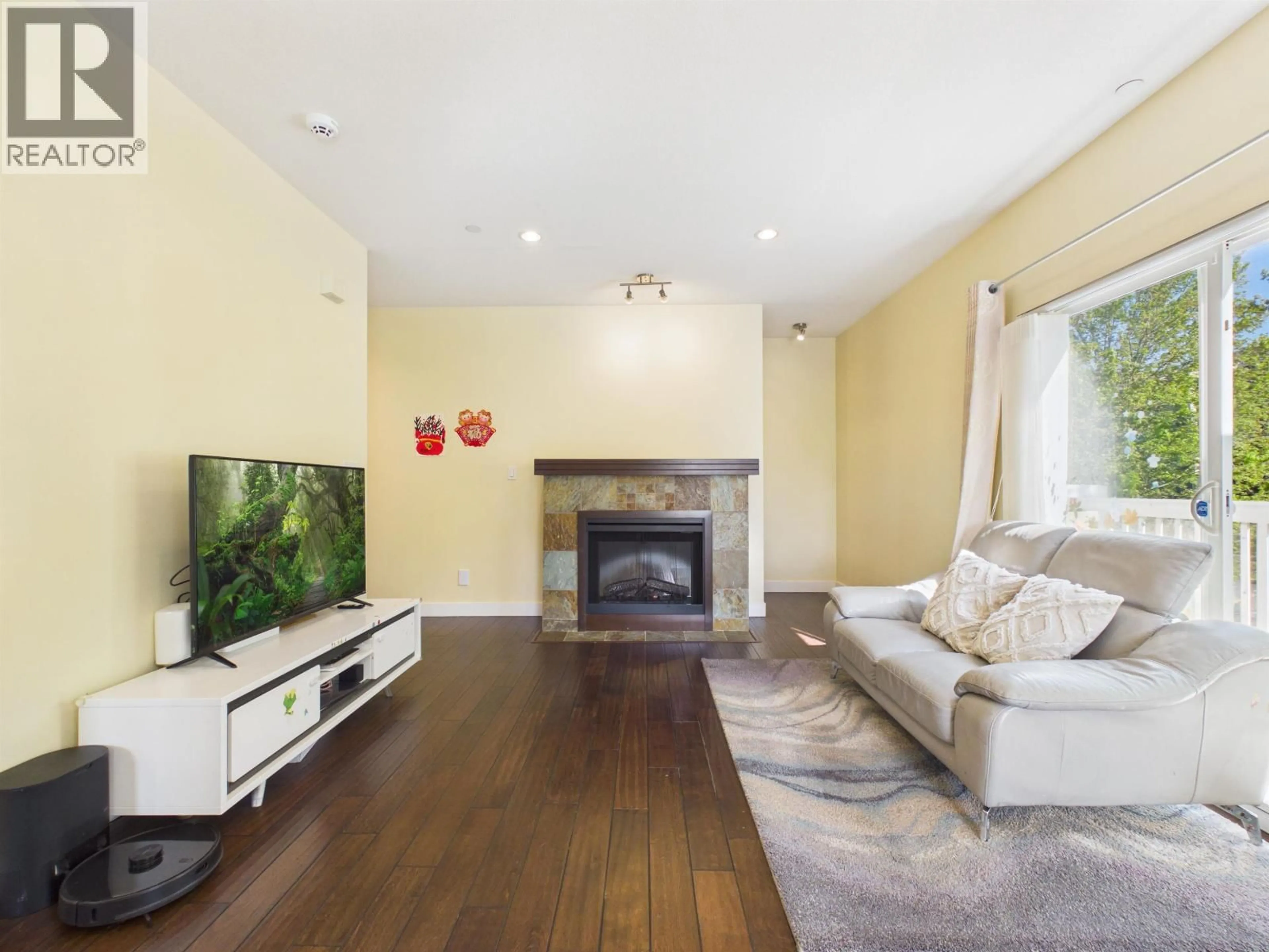 Living room with furniture, wood/laminate floor for 141 - 7388 MACPHERSON AVENUE, Burnaby British Columbia V5J0A1