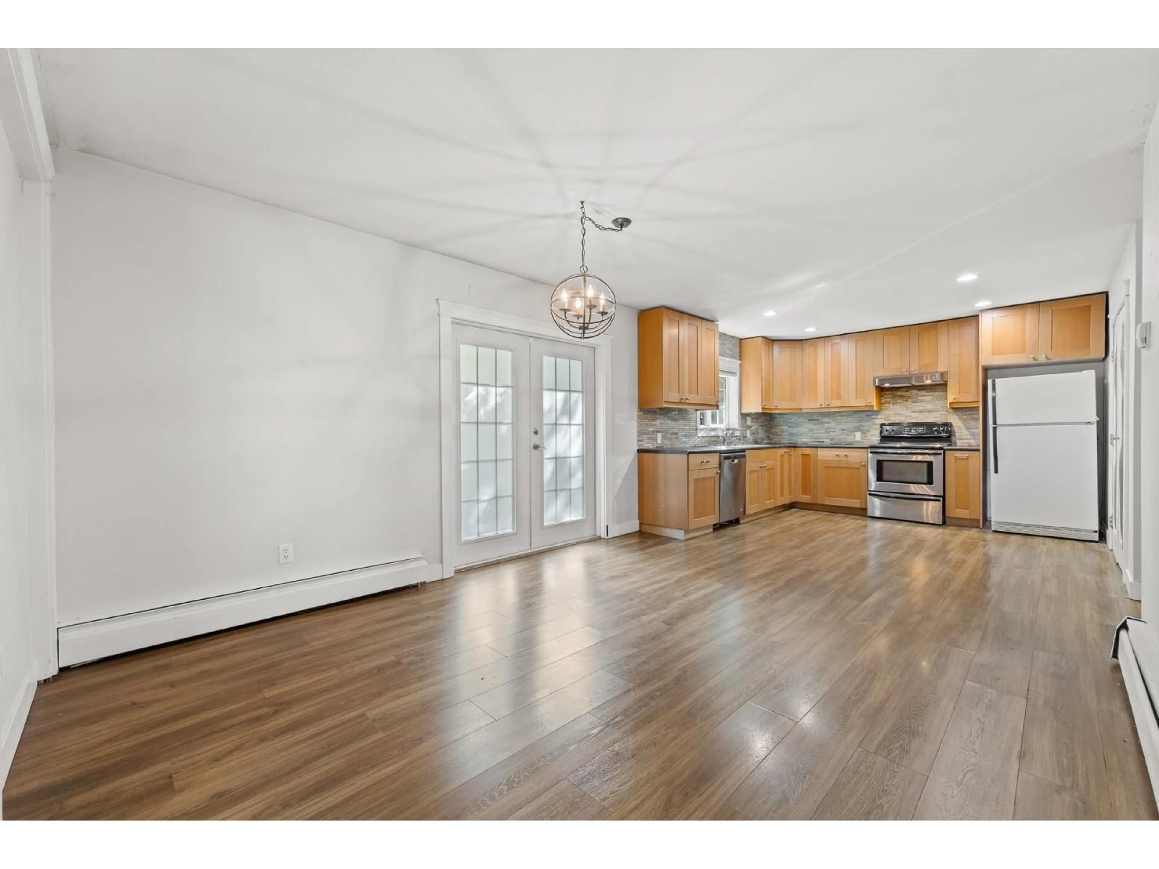 Open concept kitchen, wood/laminate floor for 12686 20 AVENUE, Surrey British Columbia V4Y1Y6
