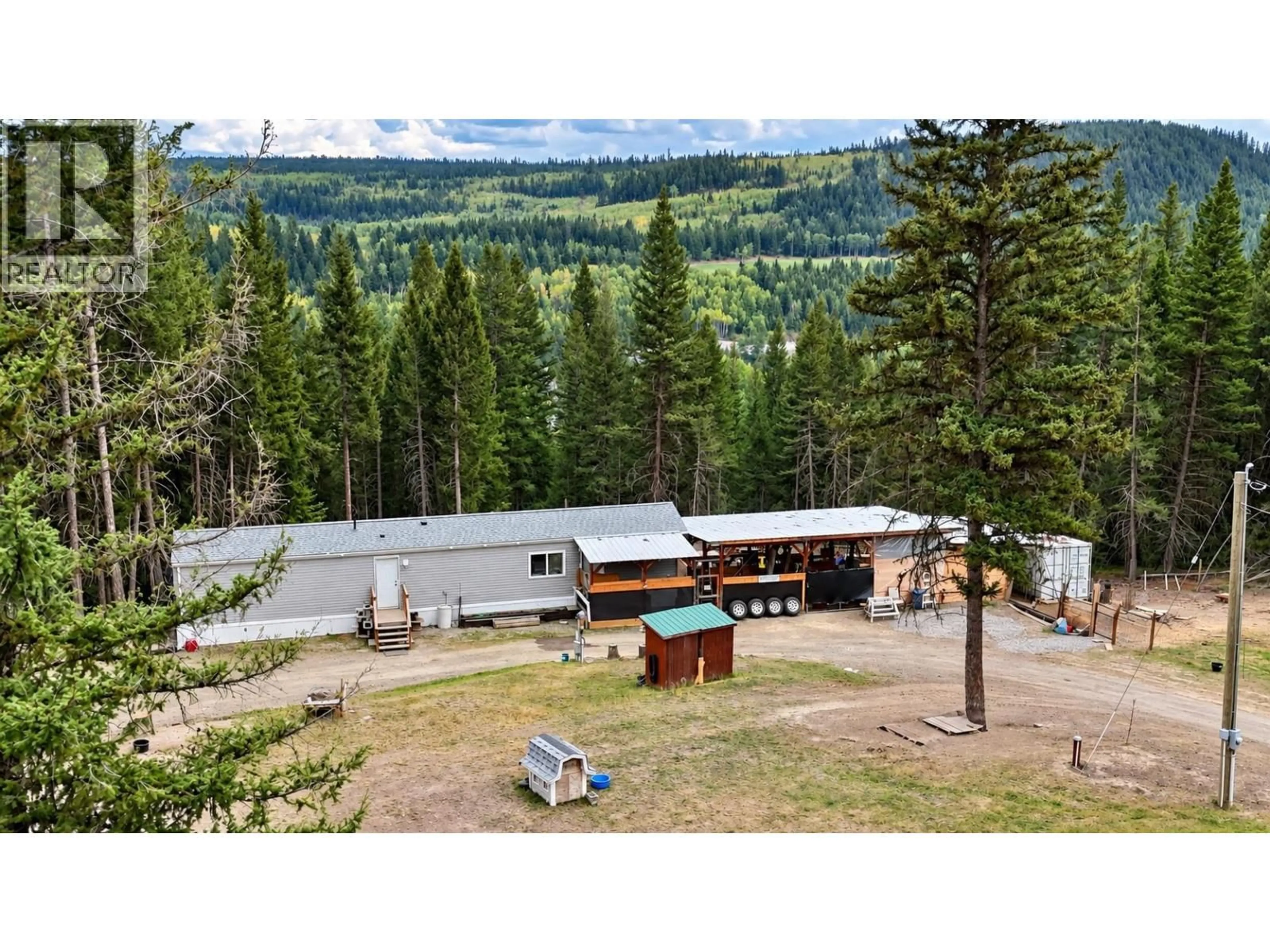 A pic from outside/outdoor area/front of a property/back of a property/a pic from drone, mountain view for 5589 BIRCHWOOD ROAD, 100 Mile House British Columbia V0K2E1