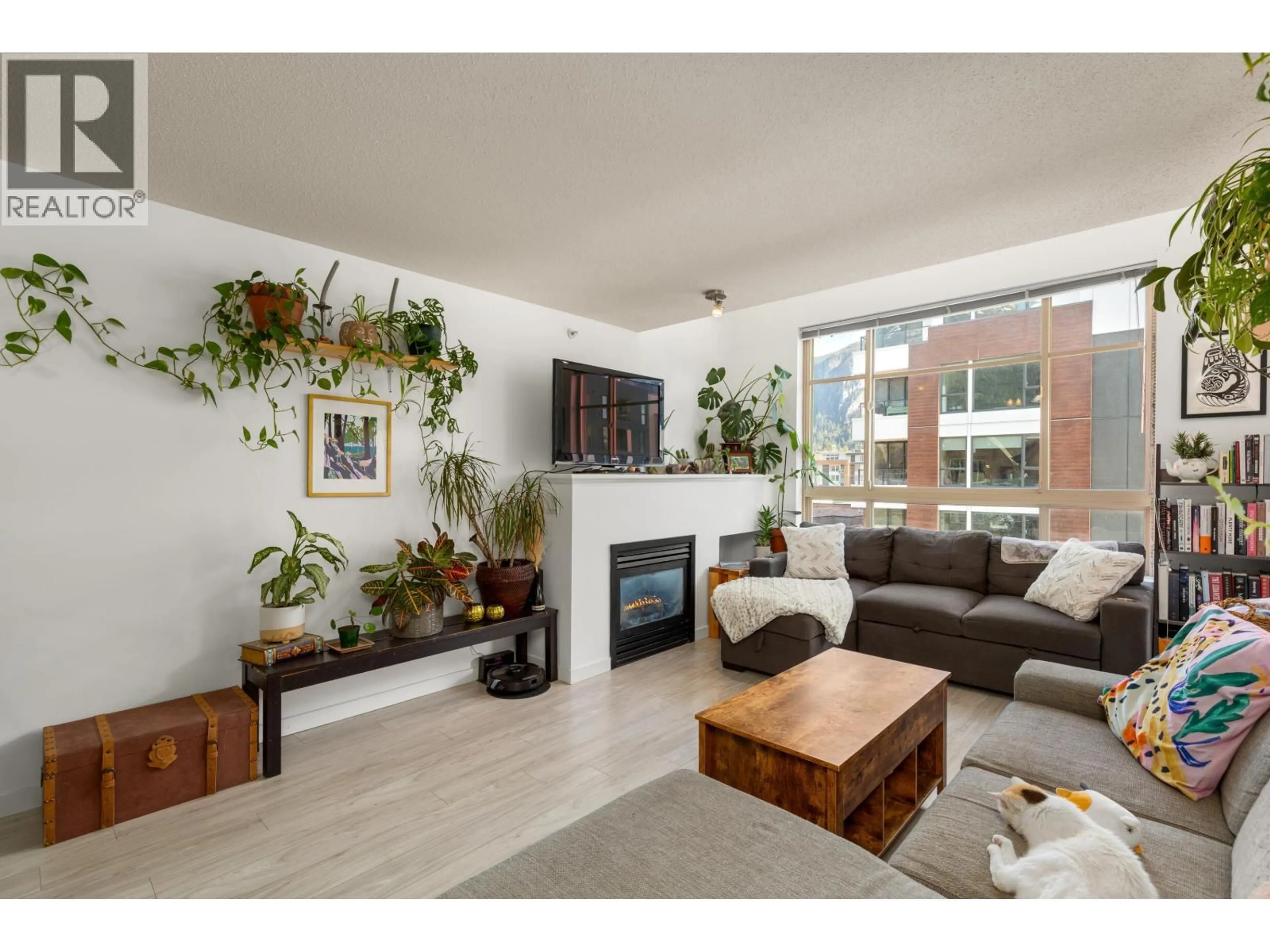 Living room with furniture, wood/laminate floor for 313 - 38003 SECOND AVENUE, Squamish British Columbia V8B0C4