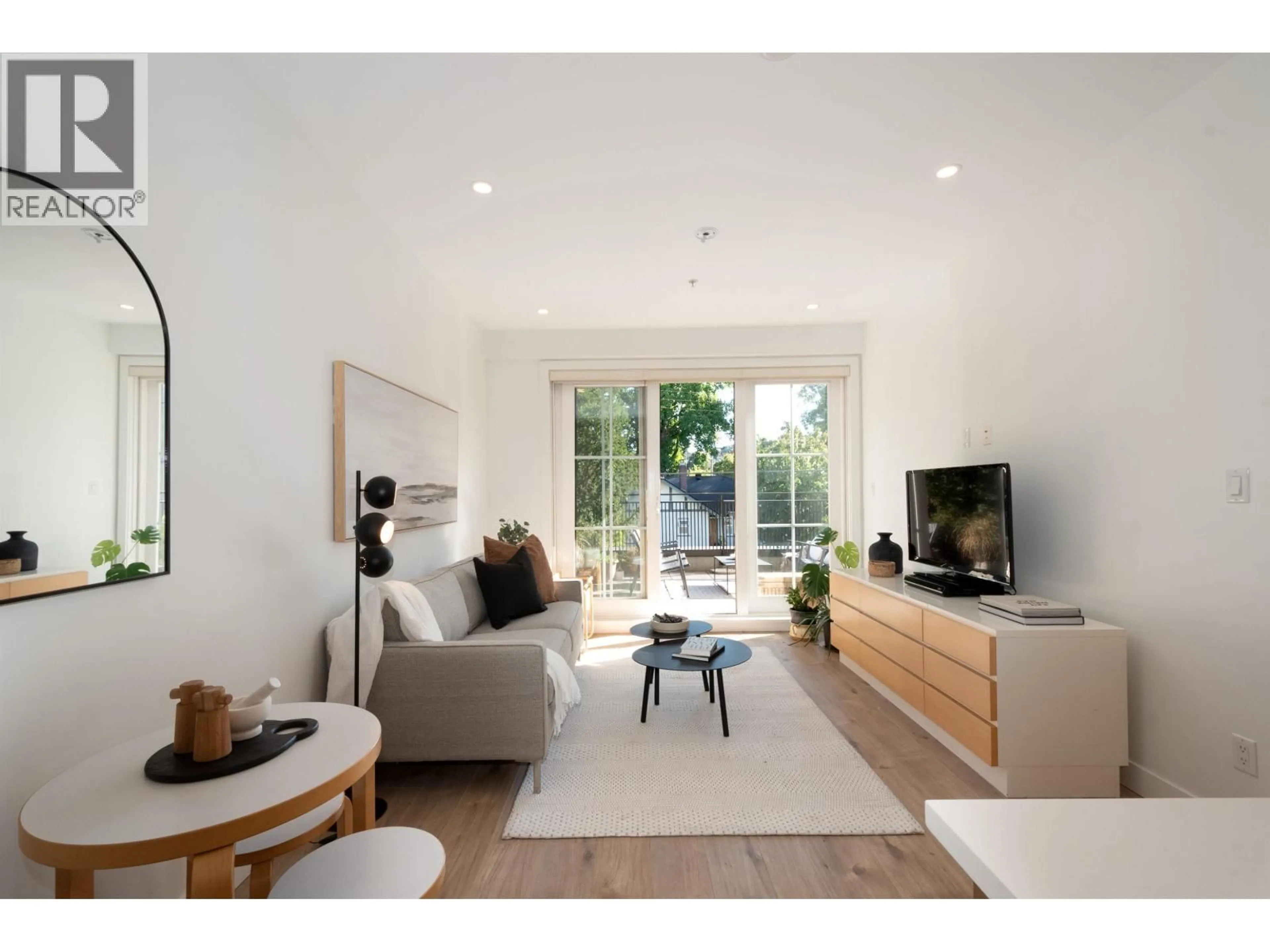 Living room with furniture, wood/laminate floor for 203 - 2528 COLLINGWOOD STREET, Vancouver British Columbia V6R0C1